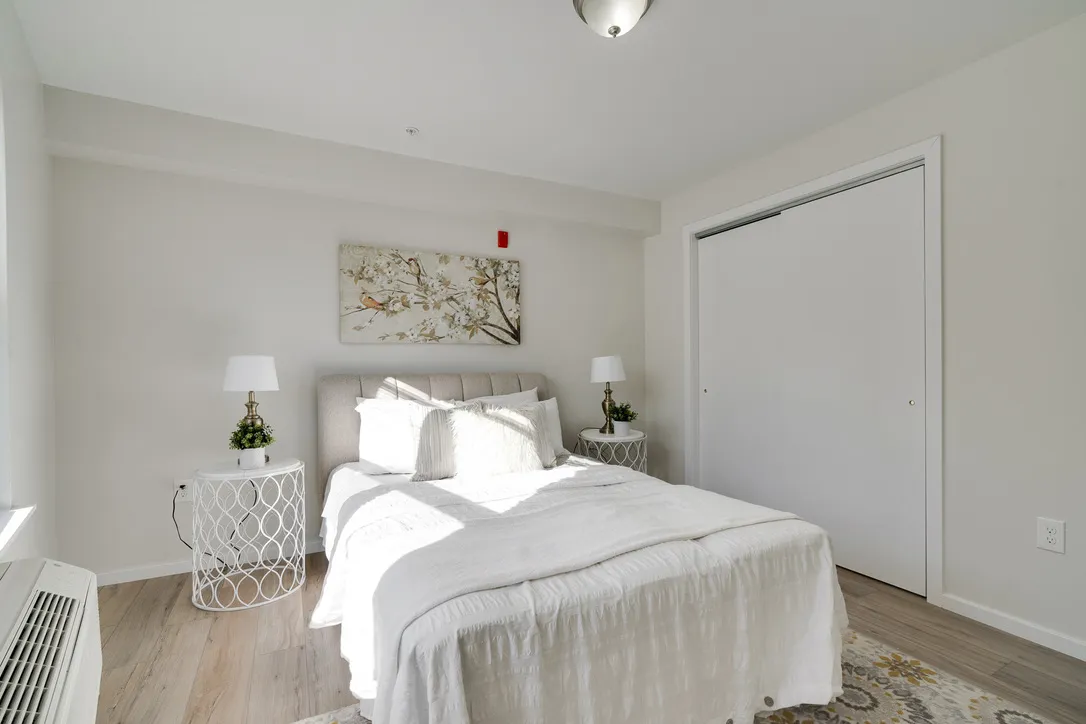a living room with furniture kitchen view and a large window
