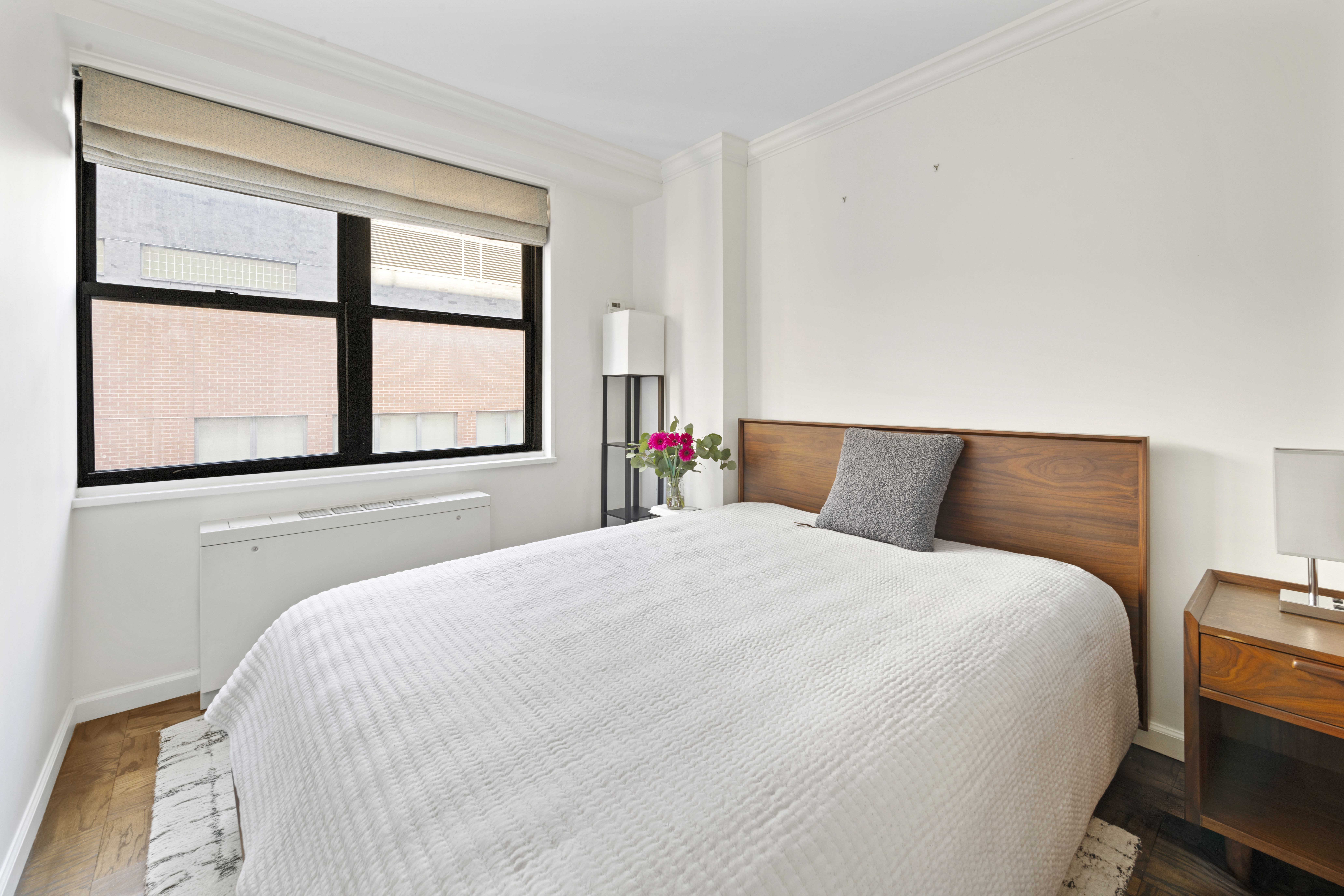 7 East 14th Street, Unit 1229 Manhattan, NY 10003 - Photo 4 of 9 a bedroom with a bed and a large window