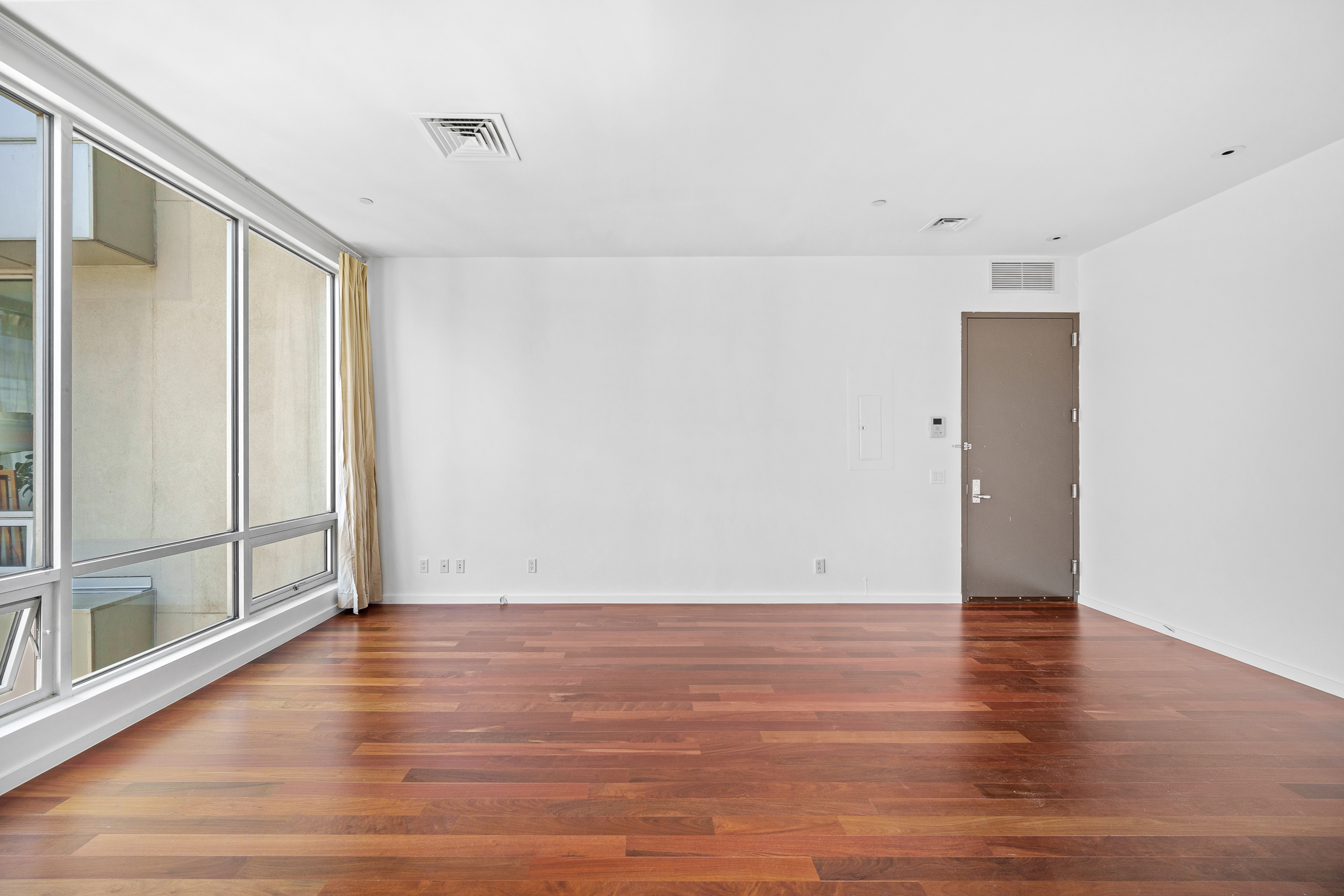 170 North 11th Street, Unit 5B Brooklyn, NY 11211 - Photo 2 of 11 a view of an empty room with wooden floor and a window