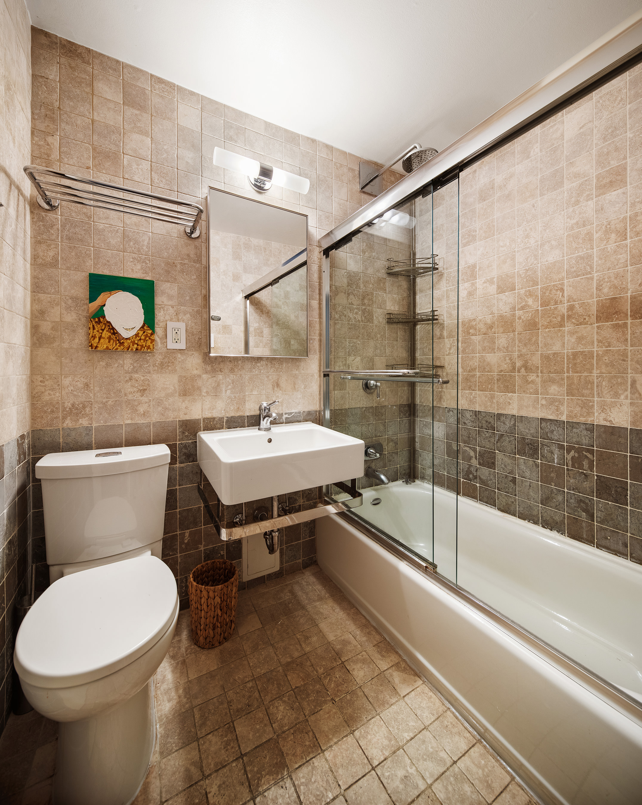 211 Thompson Street, Unit PH6D Manhattan, NY 10012 - Photo 9 of 10 a bathroom with a sink a toilet and a bathtub