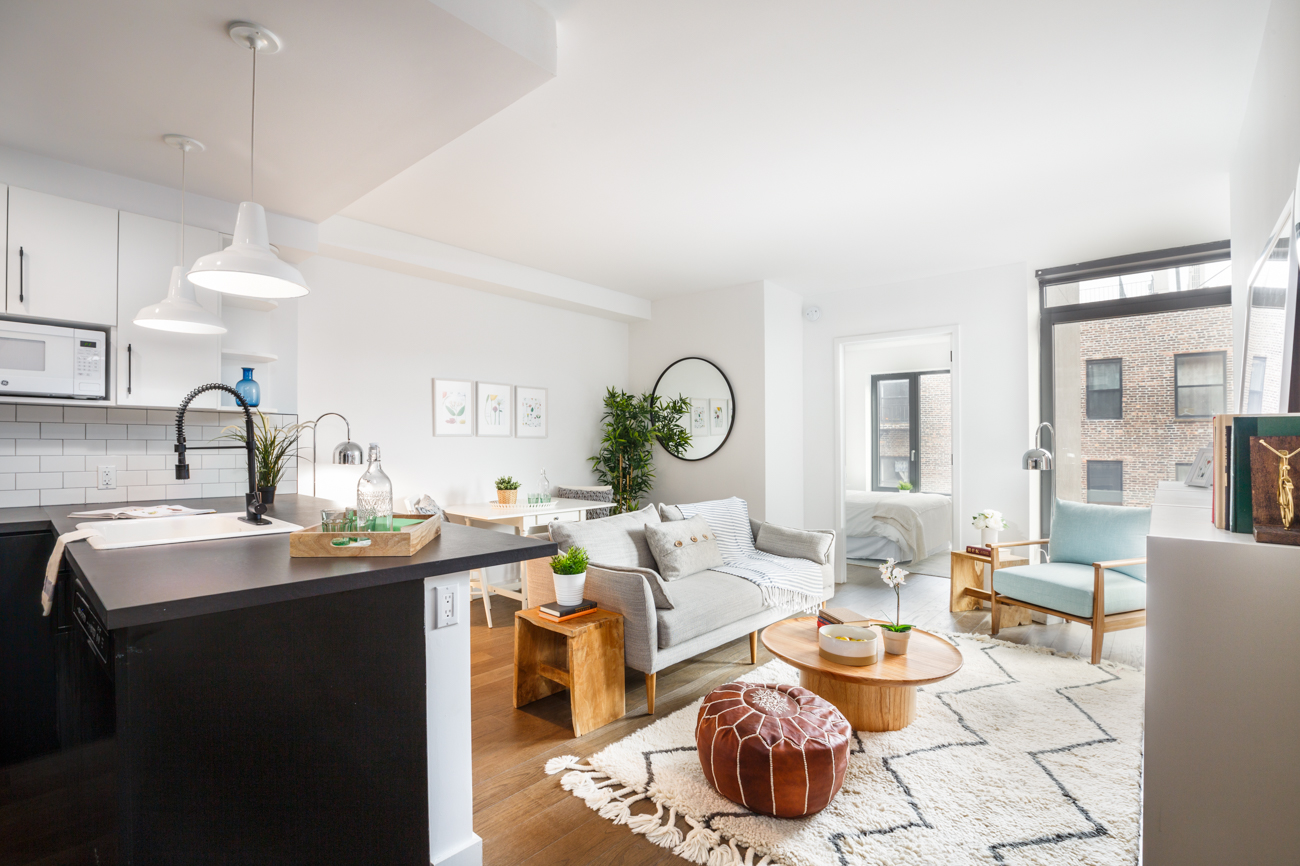 a room with a table chairs and a kitchen