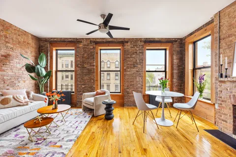 a living room with furniture and floor to ceiling windows