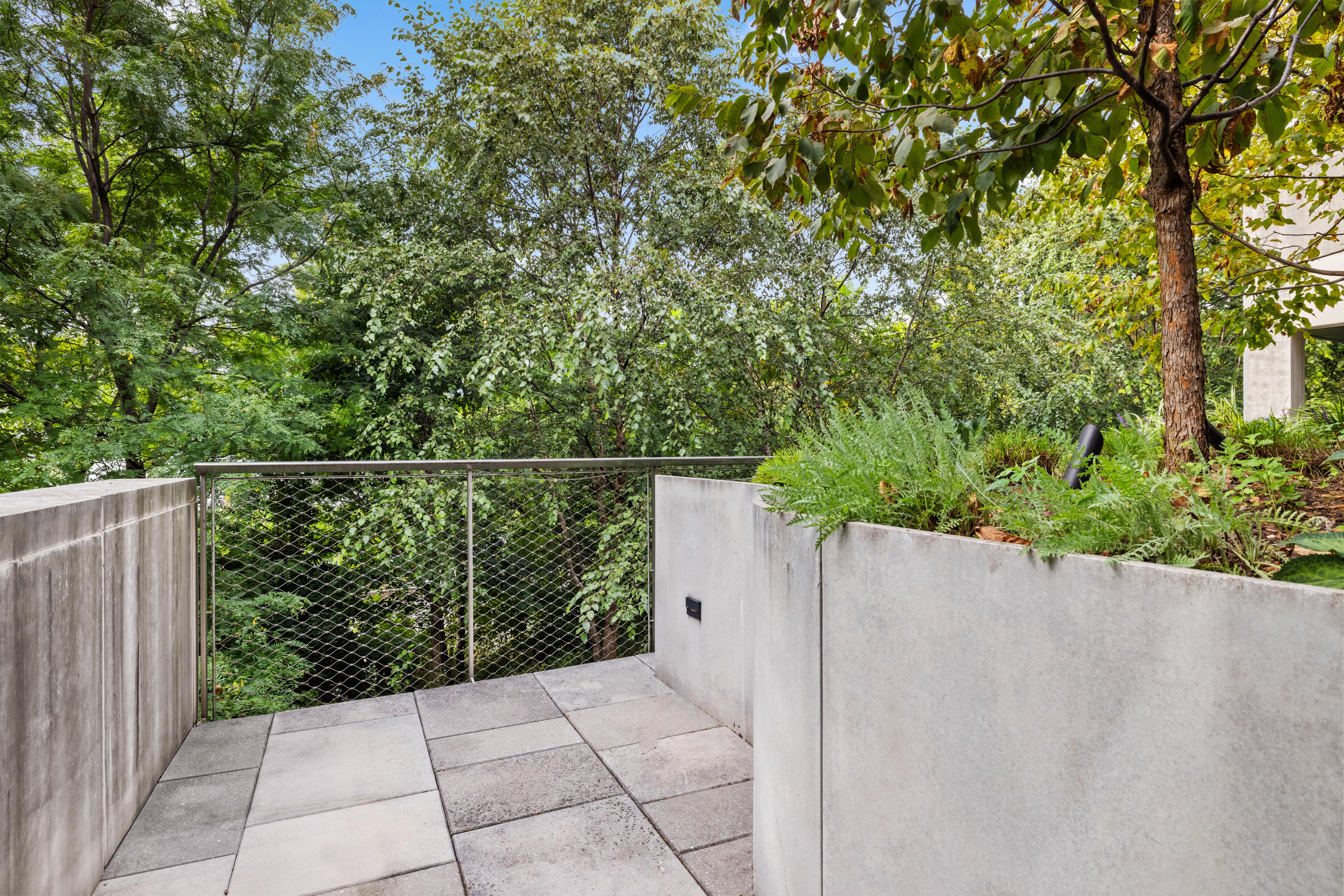 130 Furman Street, Unit S102 Brooklyn, NY 11201 - Photo 9 of 26 a view of a fence and trees