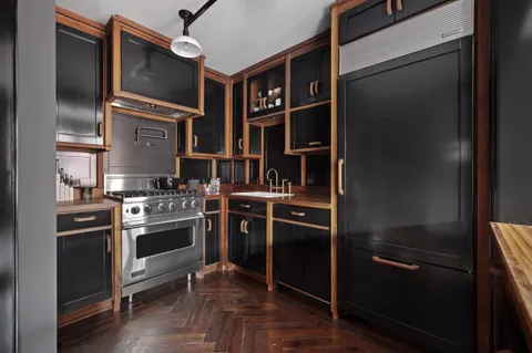 a kitchen with stainless steel appliances and a refrigerator