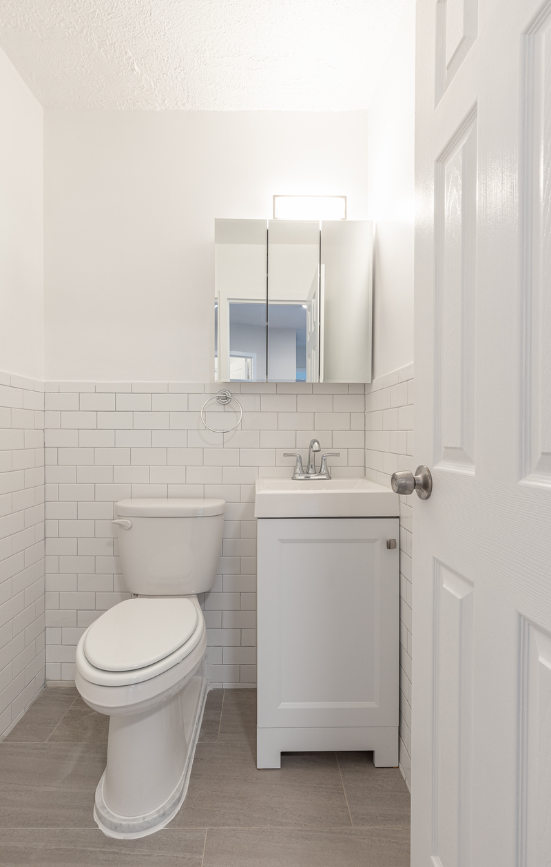 3333 Broadway, Unit E4C Manhattan, NY 10031 - Photo 9 of 23 a bathroom with a toilet sink and mirror
