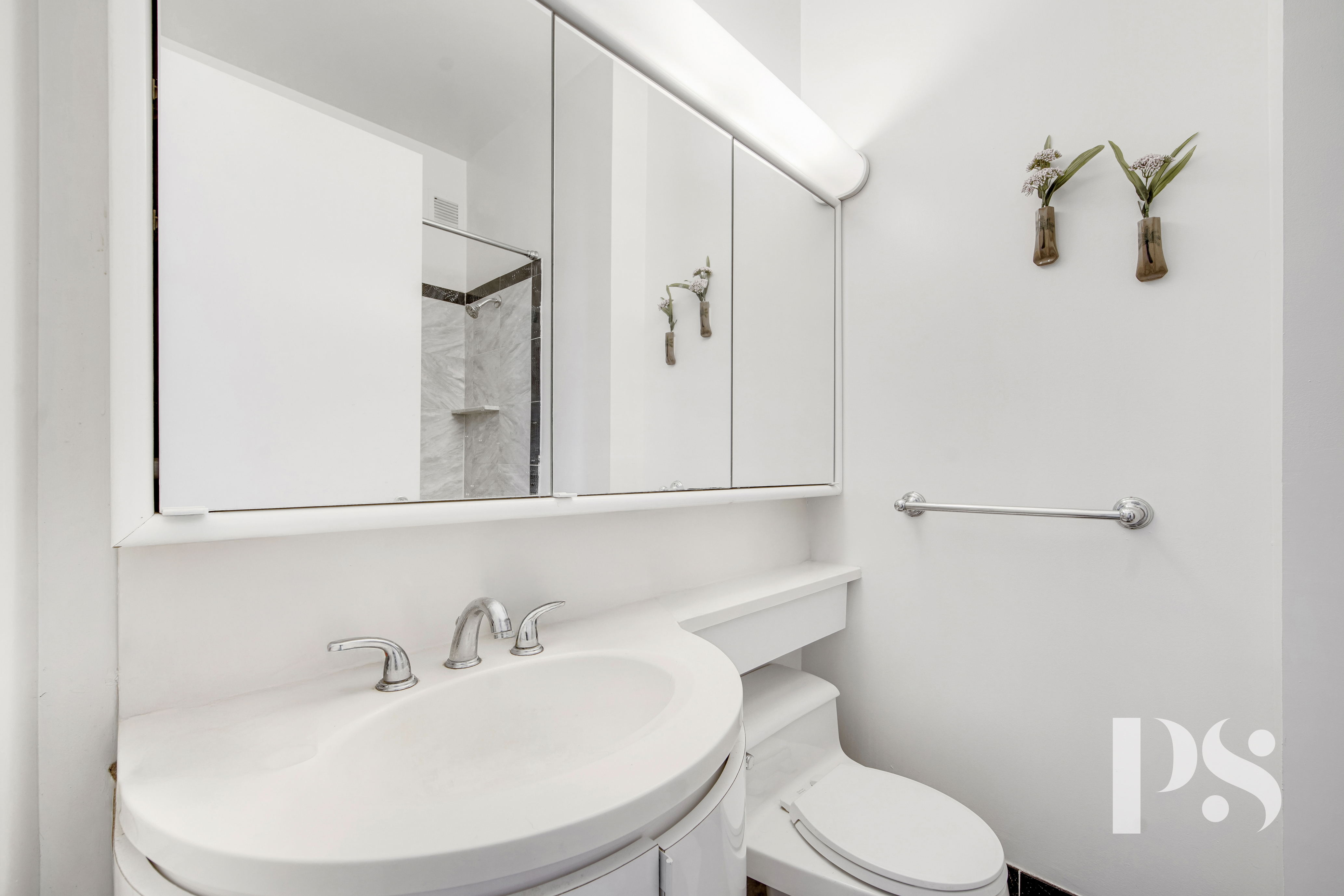 200 East 32nd Street, Unit 33C Manhattan, NY 10016 - Photo 9 of 12 a bathroom with a toilet sink and shower