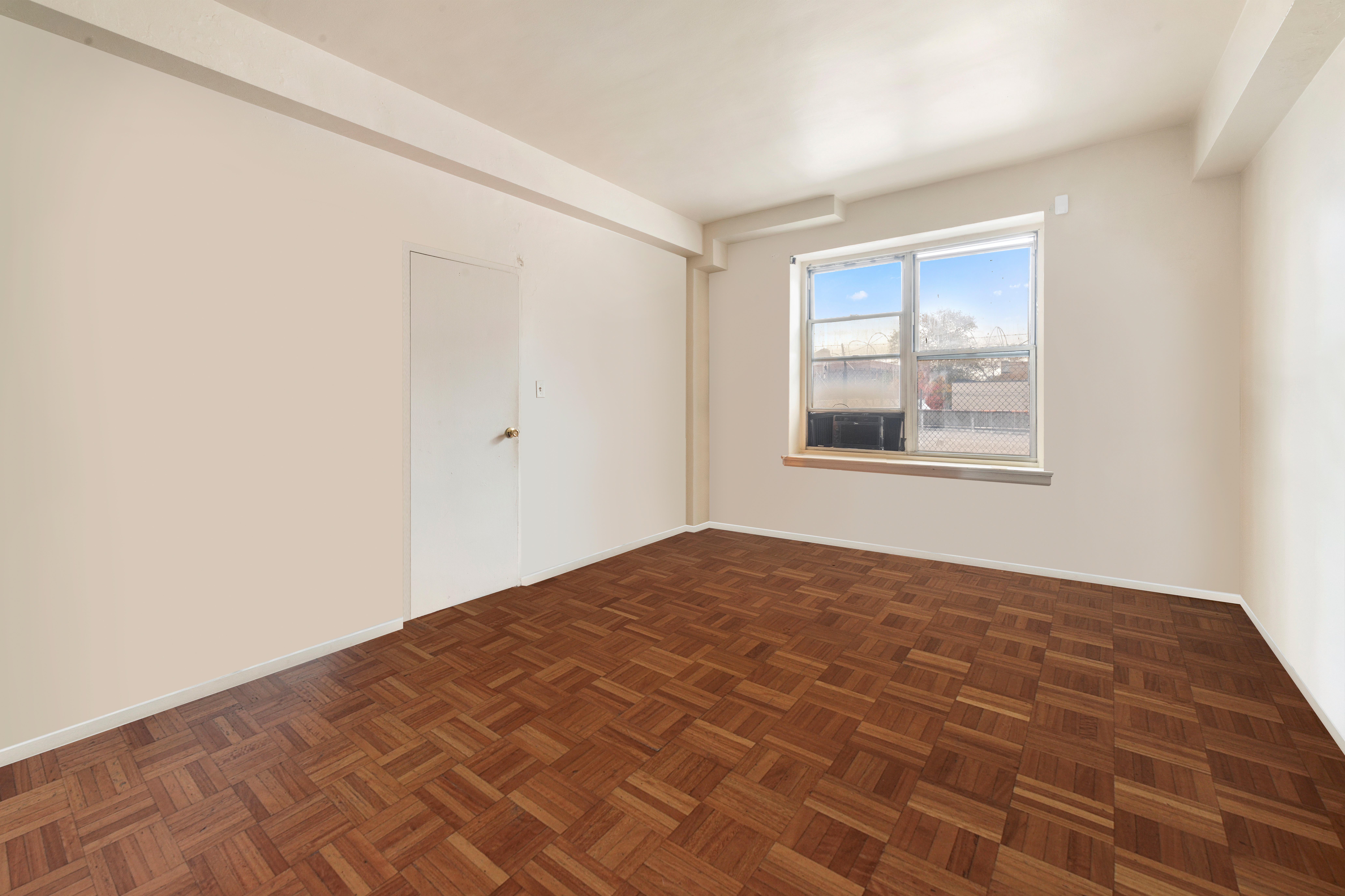 800 Grand Concourse, Unit GMS Bronx, NY 10451 - Photo 5 of 13 a view of empty room with wooden floor and fan