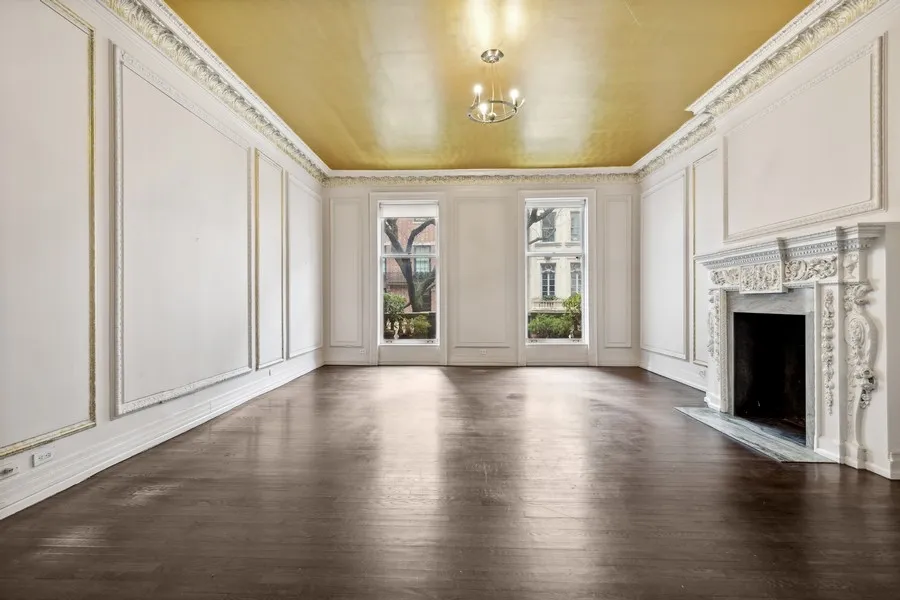 a view of an empty room with window and fireplace