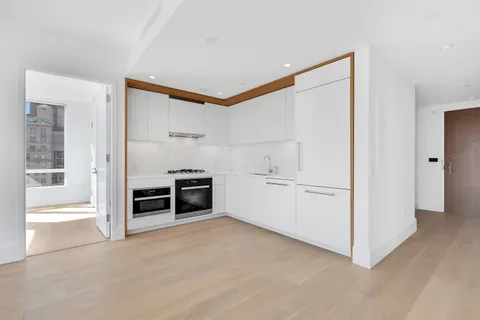 a view of kitchen with furniture and white cabinets