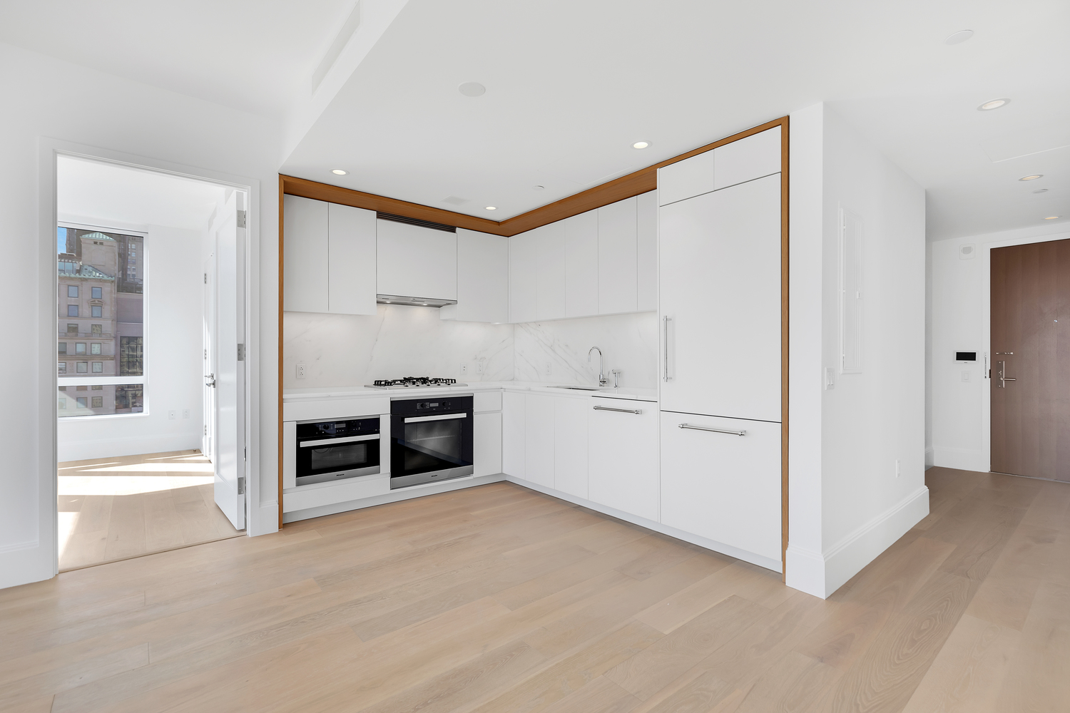 368 3rd Avenue, Unit 15C Manhattan, NY 10016 - Photo 4 of 17 a view of kitchen with furniture and white cabinets