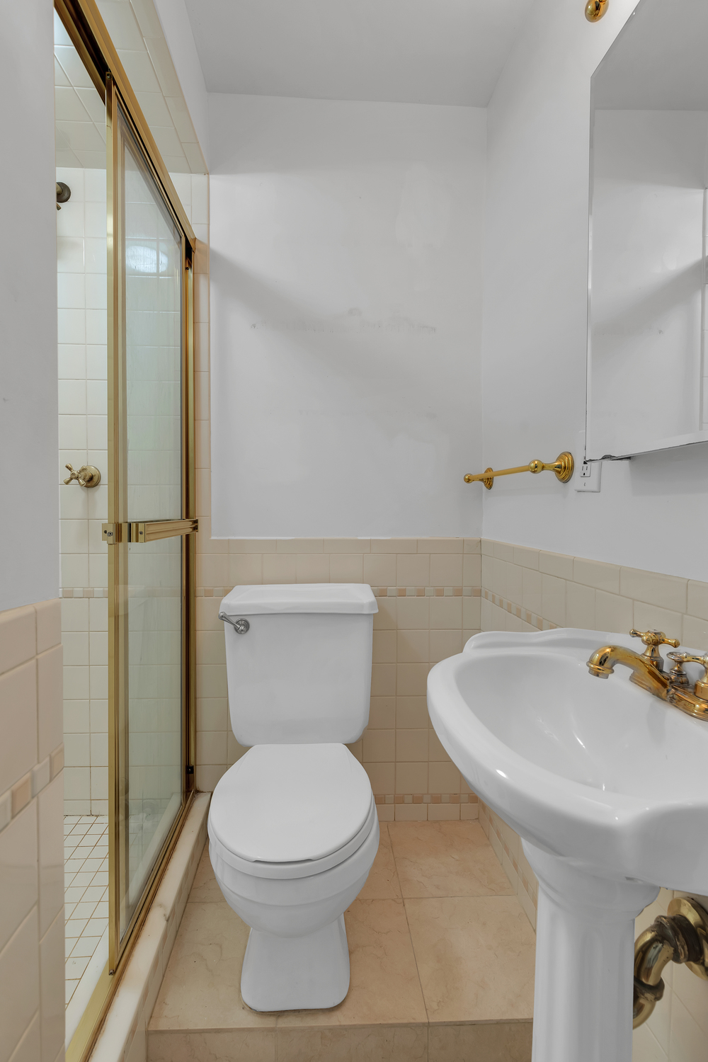 1045 Park Avenue, Unit 5A Manhattan, NY 10028 - Photo 8 of 10 a bathroom with a sink a toilet and shower