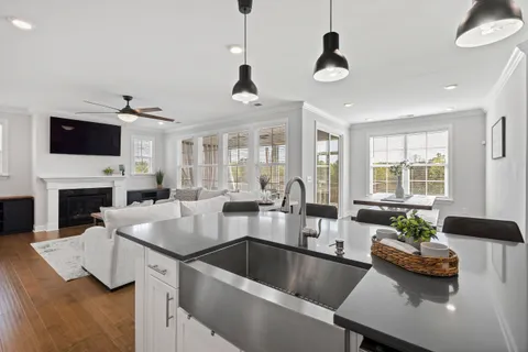 a living room with fireplace furniture and a flat screen tv
