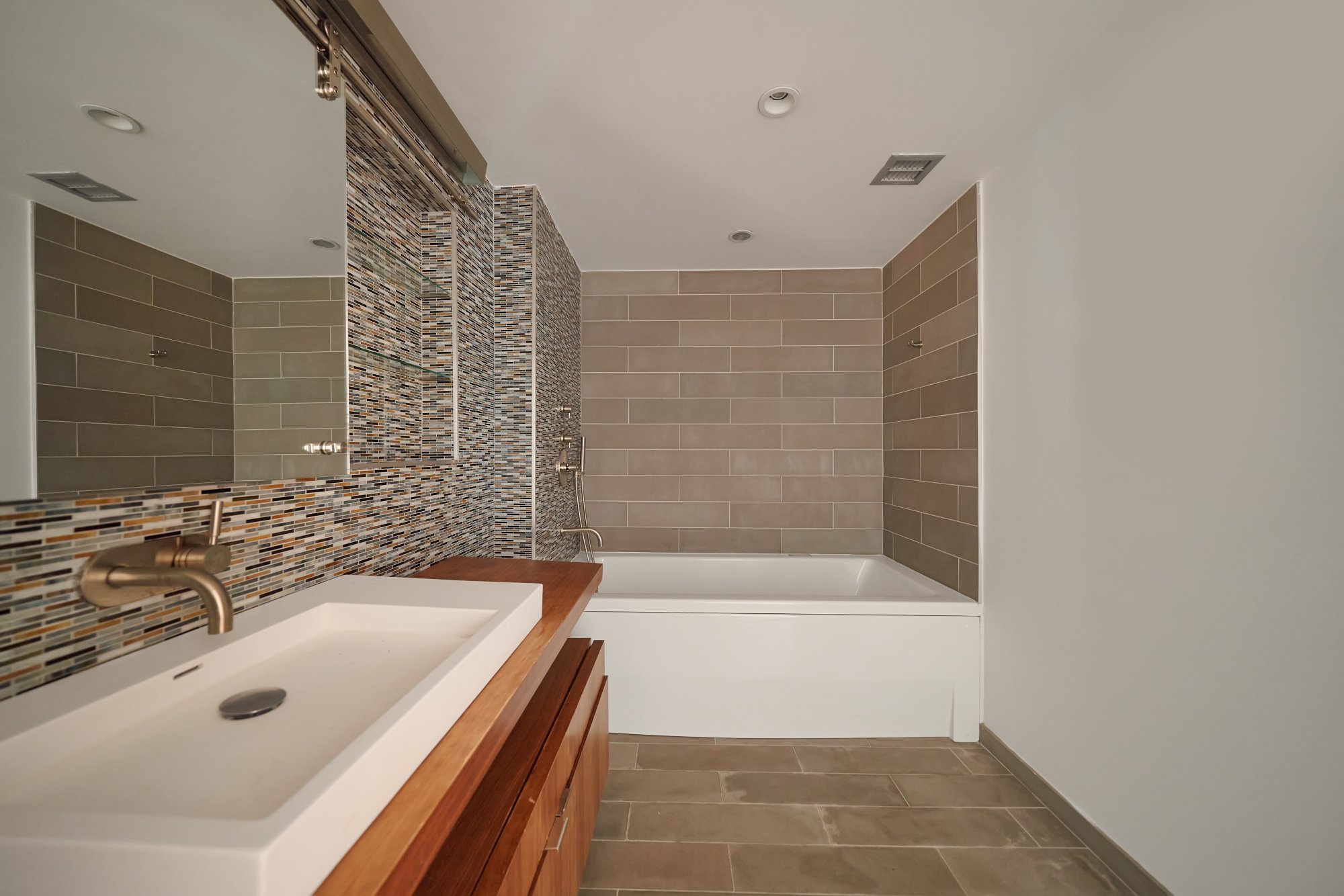 2280 Frederick Douglass Boulevard, Unit 5D Manhattan, NY 10027 - Photo 13 of 22 a bathroom with a tub a sink and a shower