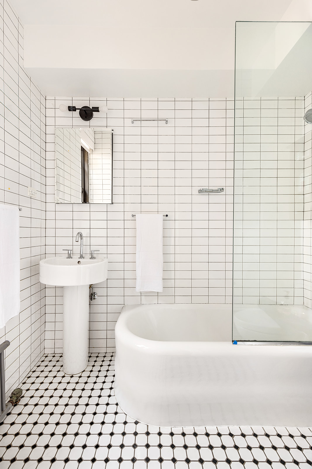 135 Eastern Parkway, Unit 13E Brooklyn, NY 11238 - Photo 11 of 15 a bathroom with a bathtub and a sink