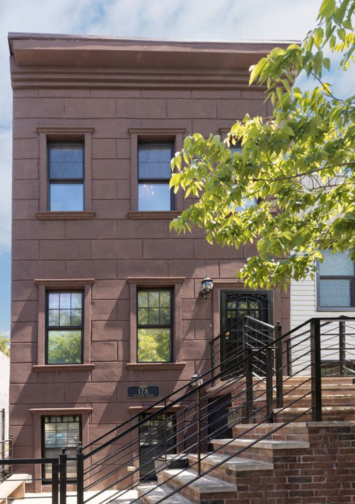 17 A Suydam Place, Unit 2 Brooklyn, NY 11233 - Photo 26 of 28 a front view of a house with lots of yellow lighting
