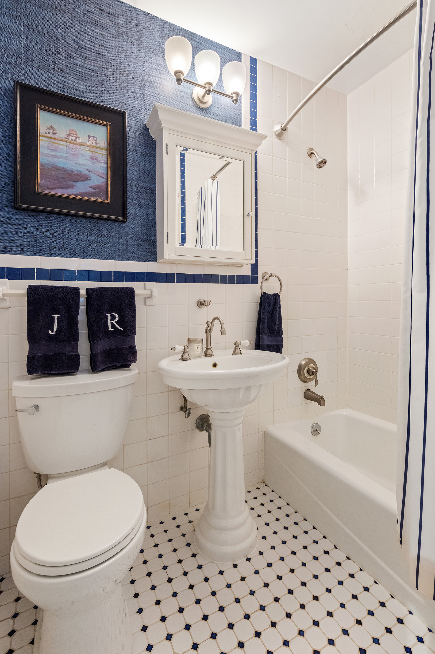 135 East 83rd Street, Unit 14D Manhattan, NY 10028 - Photo 7 of 8 a bathroom with a sink a toilet and shower