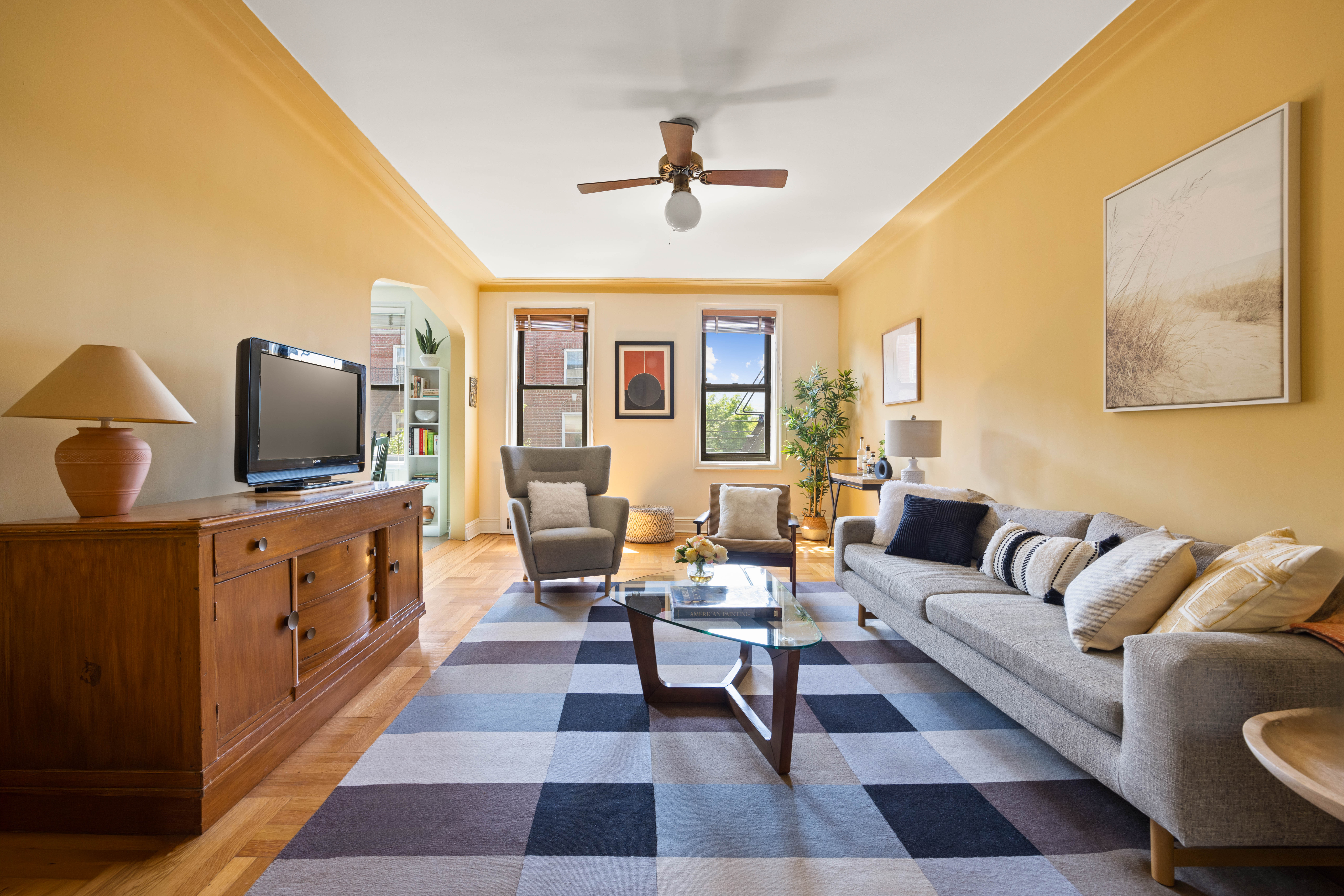 a living room with furniture and a flat screen tv