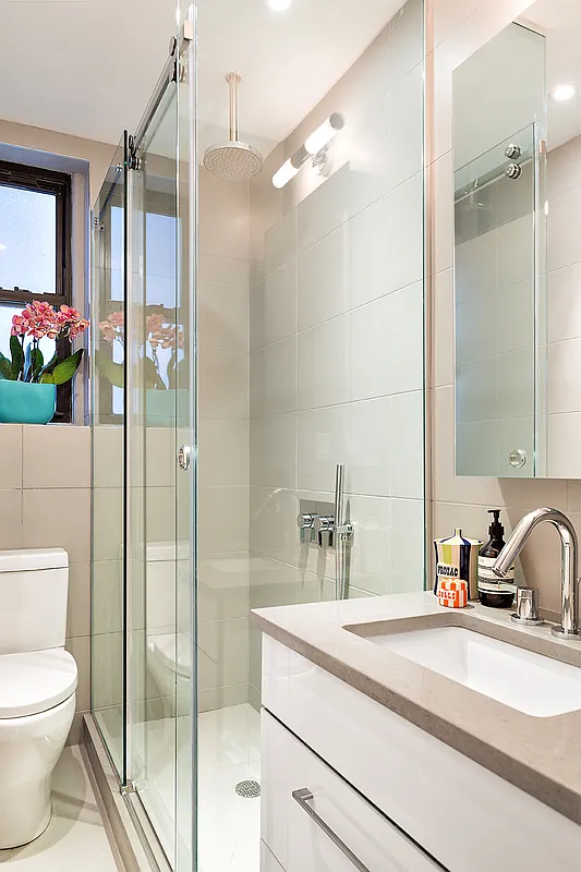 245 West 25th Street, Unit 1P Manhattan, NY 10001 - Photo 6 of 13 a bathroom with a sink a toilet and shower