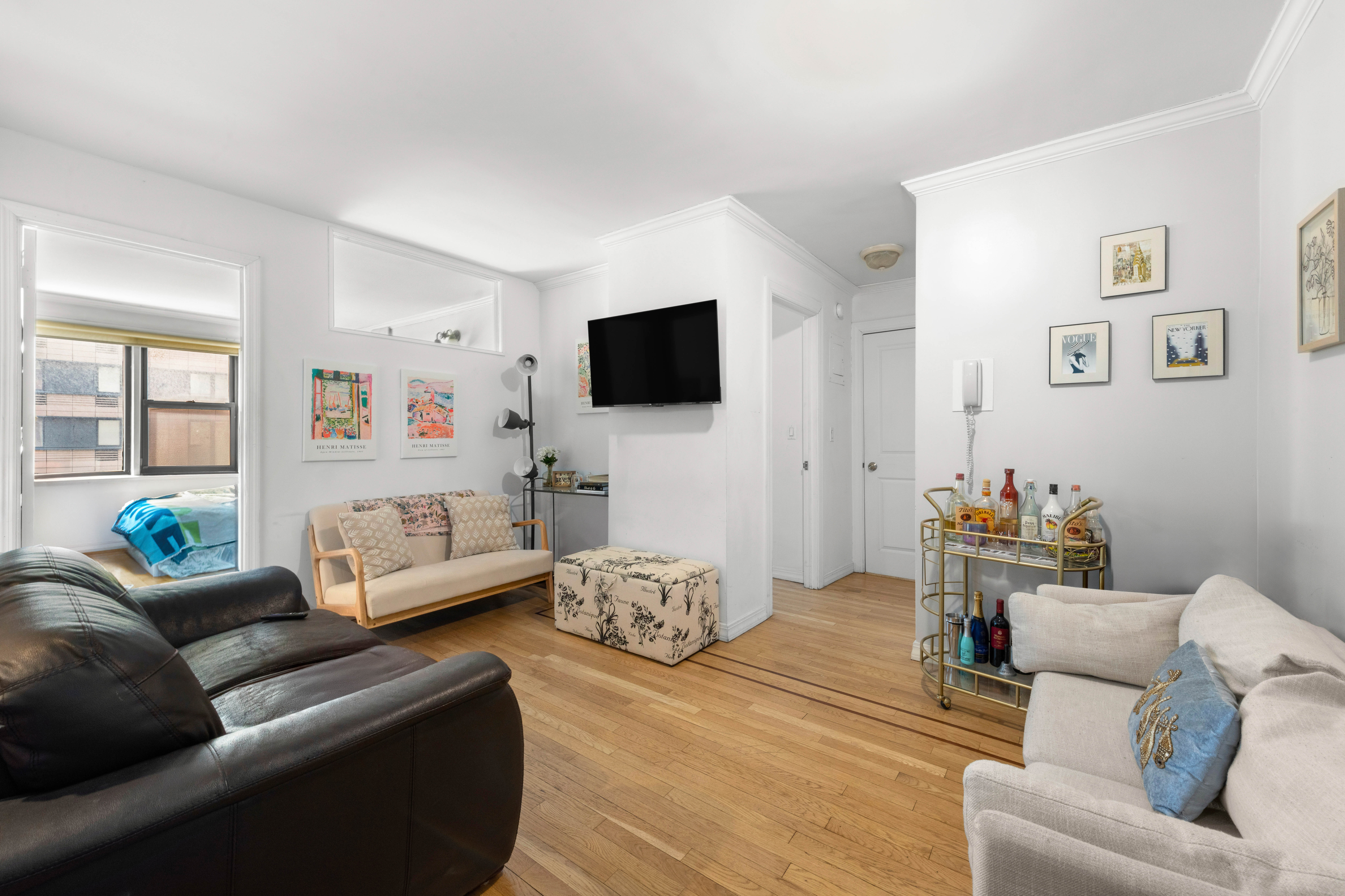 333 East 34th Street, Unit 5E Manhattan, NY 10016 - Photo 4 of 13 a living room with furniture and a flat screen tv