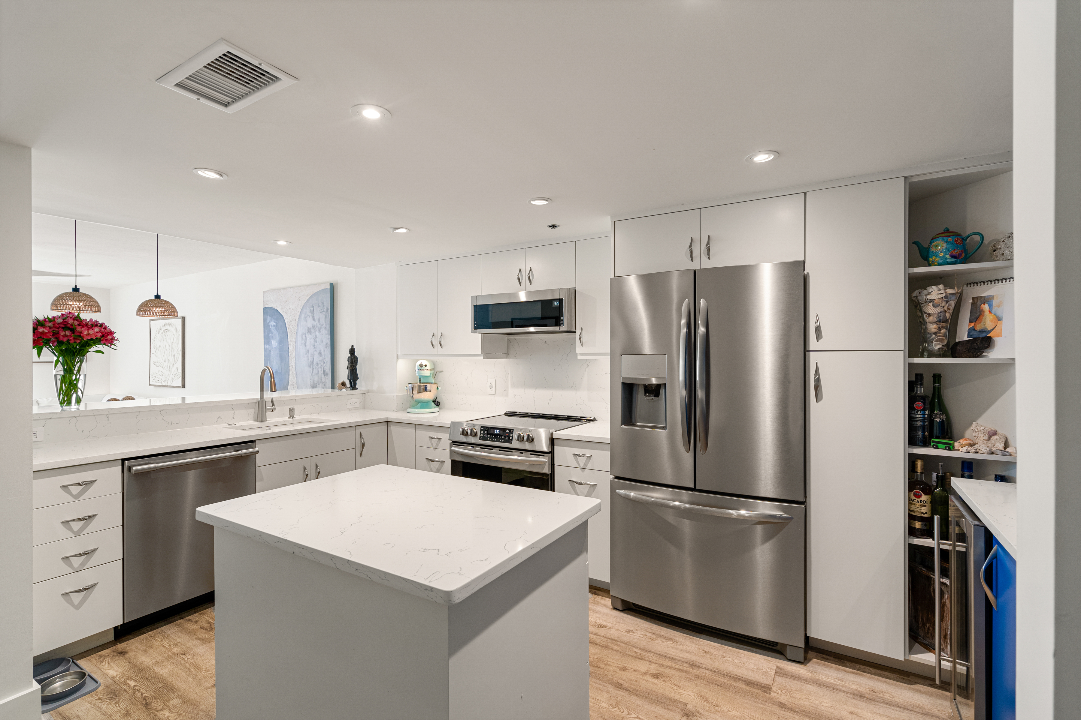 2700 North Highway A1a, Unit 207 Fort Pierce, FL 34949 - Photo 8 of 36 a kitchen with a refrigerator a sink dishwasher and a refrigerator with wooden floor