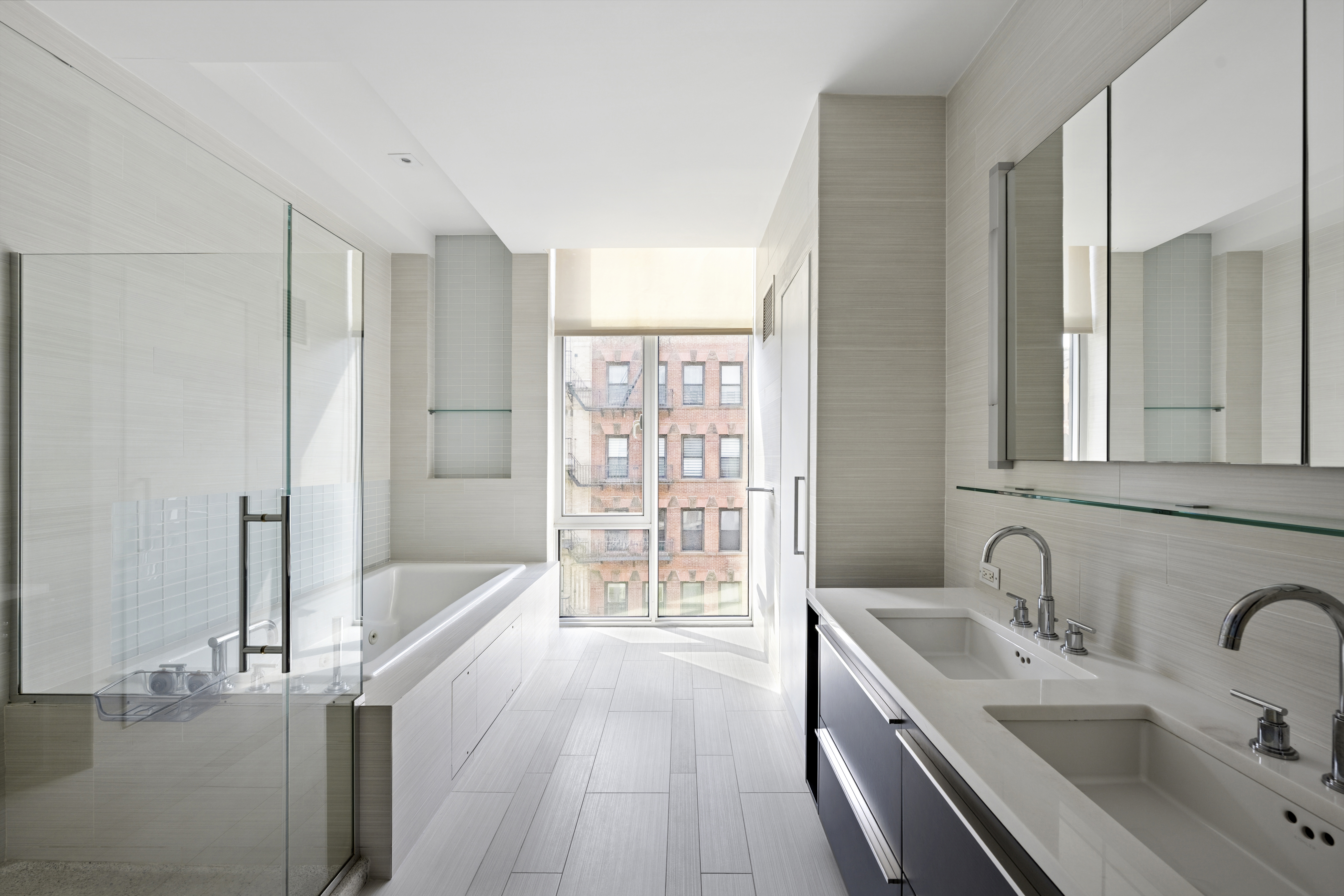 475 Greenwich Street, Unit 5B Manhattan, NY 10013 - Photo 7 of 16 a bathroom with a tub sink and mirror