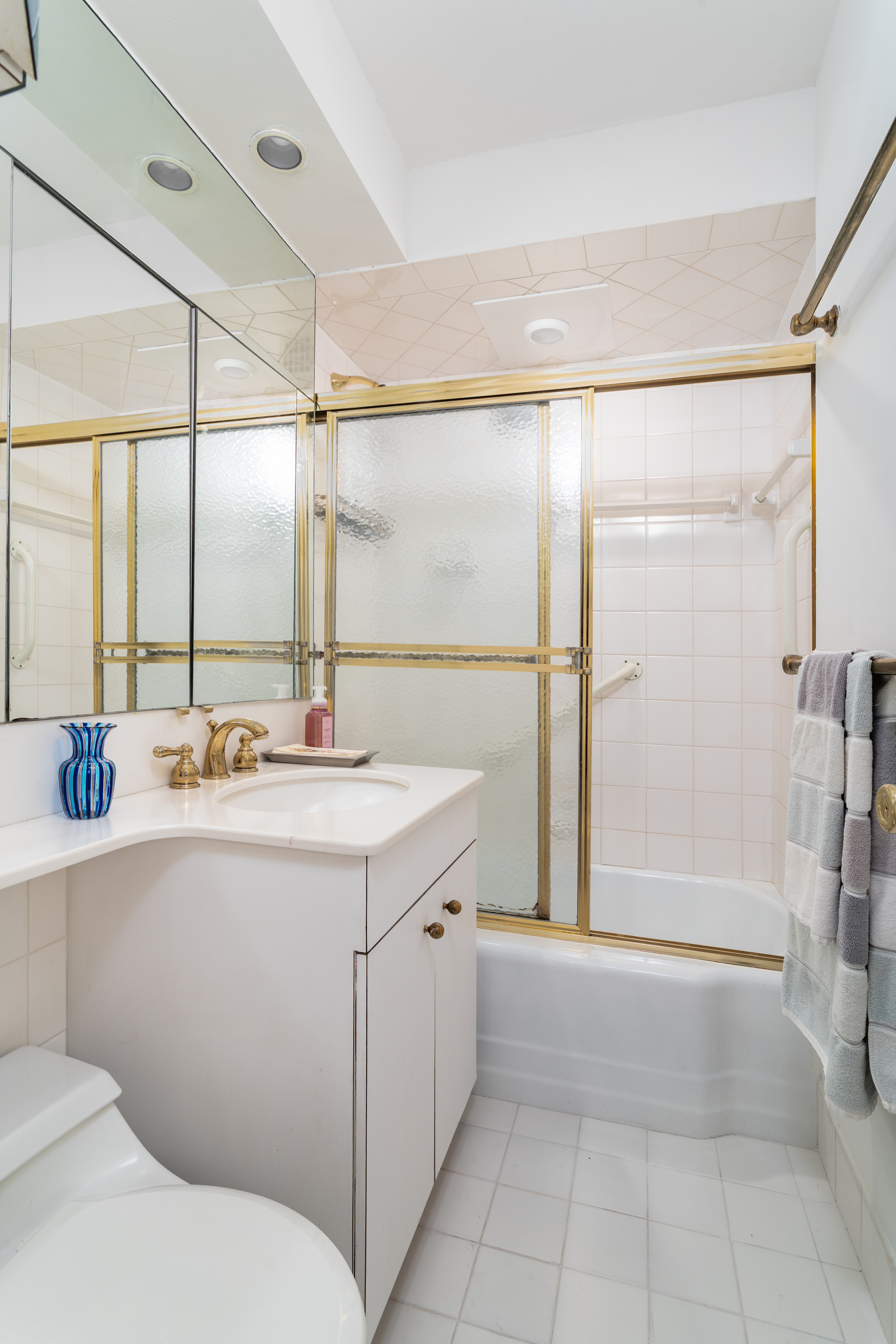 251 East 51st Street, Unit 6K Manhattan, NY 10022 - Photo 8 of 16 a bathroom with a sink and mirror