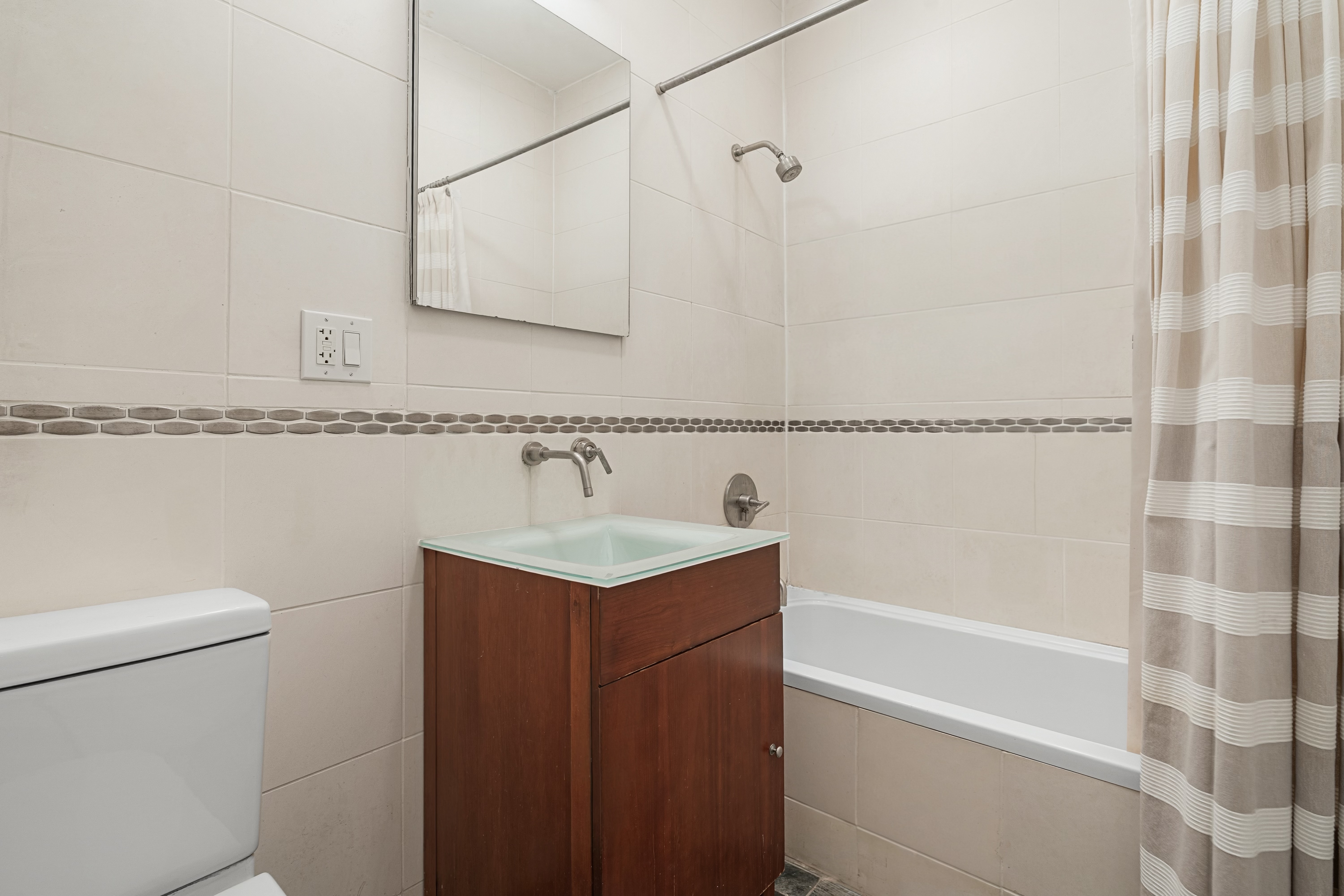 552 West 43rd Street, Unit 3A Manhattan, NY 10036 - Photo 8 of 11 a bathroom with a sink a toilet and shower