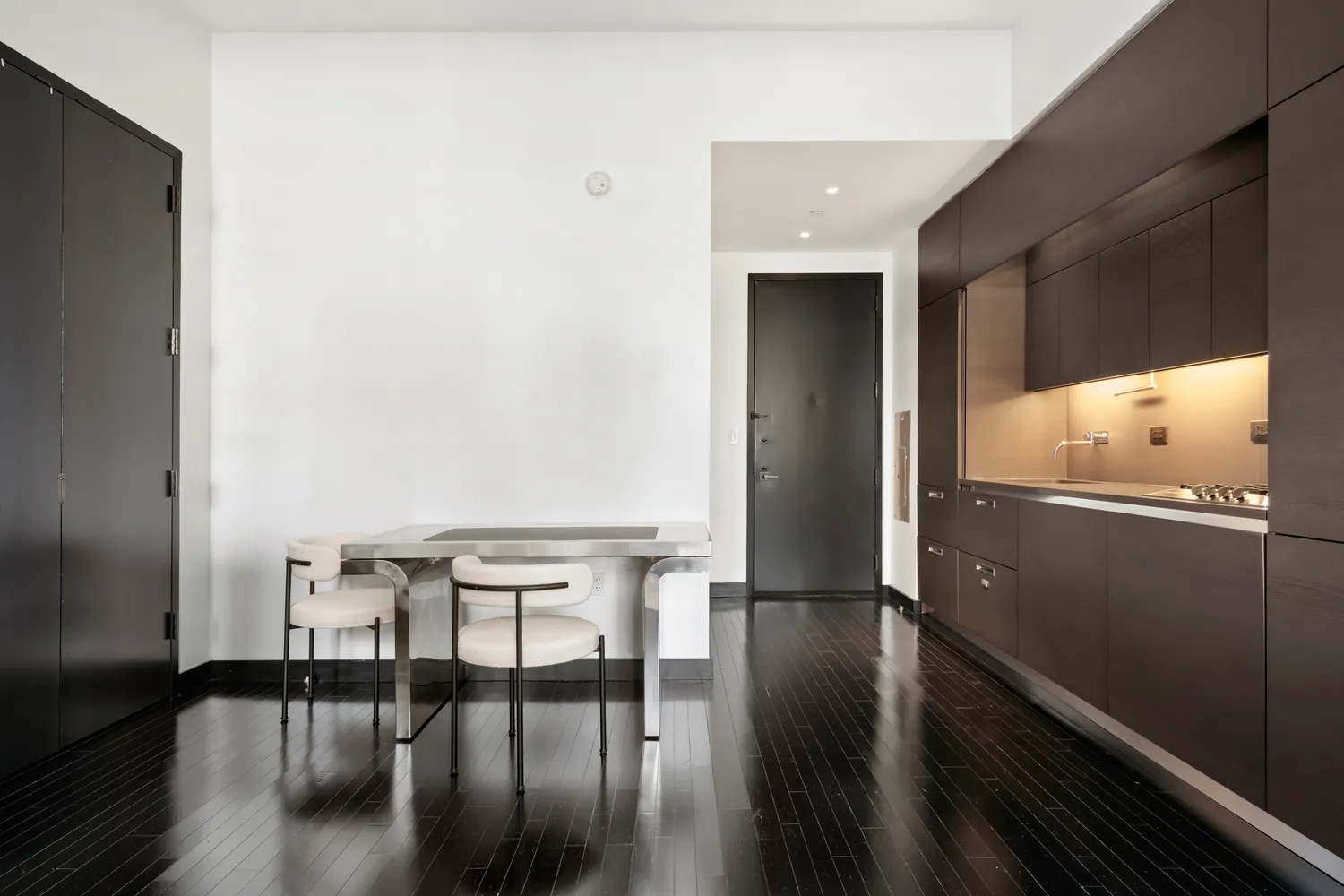 a view of a hallway with wooden floor