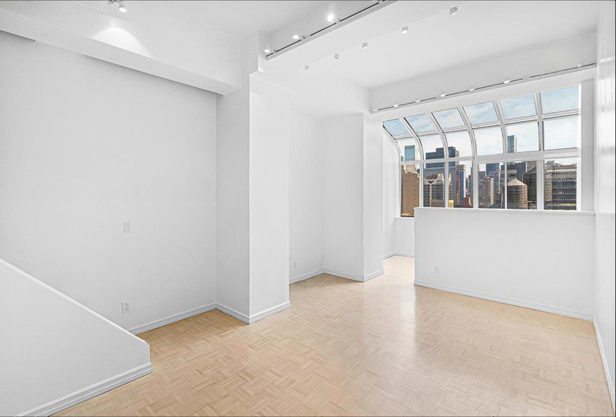 310 East 46th Street, Unit 19F Manhattan, NY 10017 - Photo 10 of 17 an empty room with windows