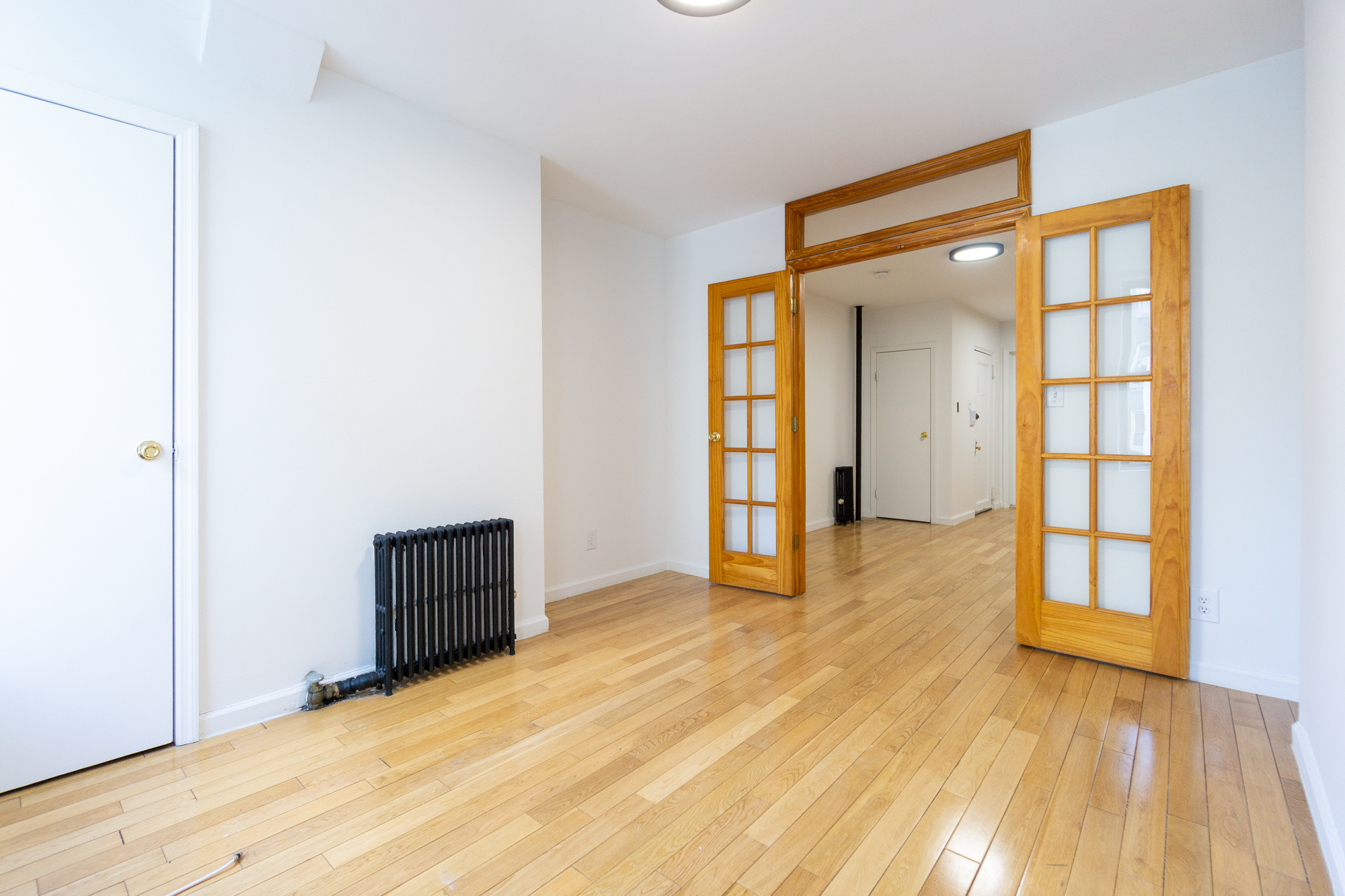 337 East 6th Street, Unit 9 Manhattan, NY 10003 - Photo 4 of 15 wooden floor in an empty room
