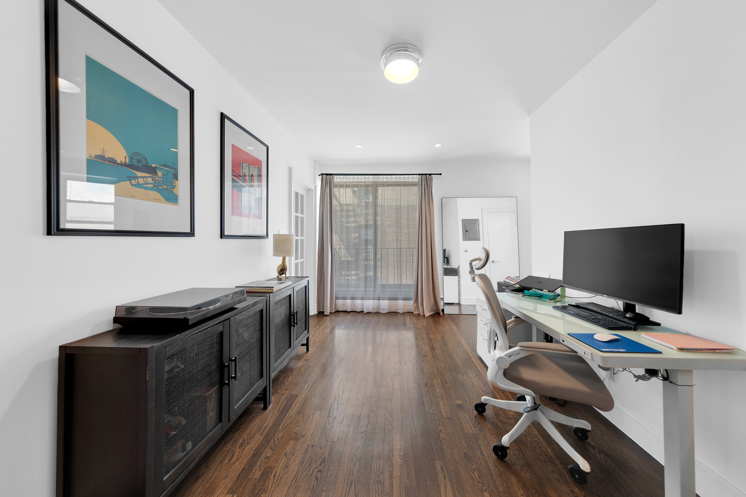 175 East 2nd Street, Unit 4D Manhattan, NY 10009 - Photo 4 of 8 a view of a workspace with wooden floor and white cabinet