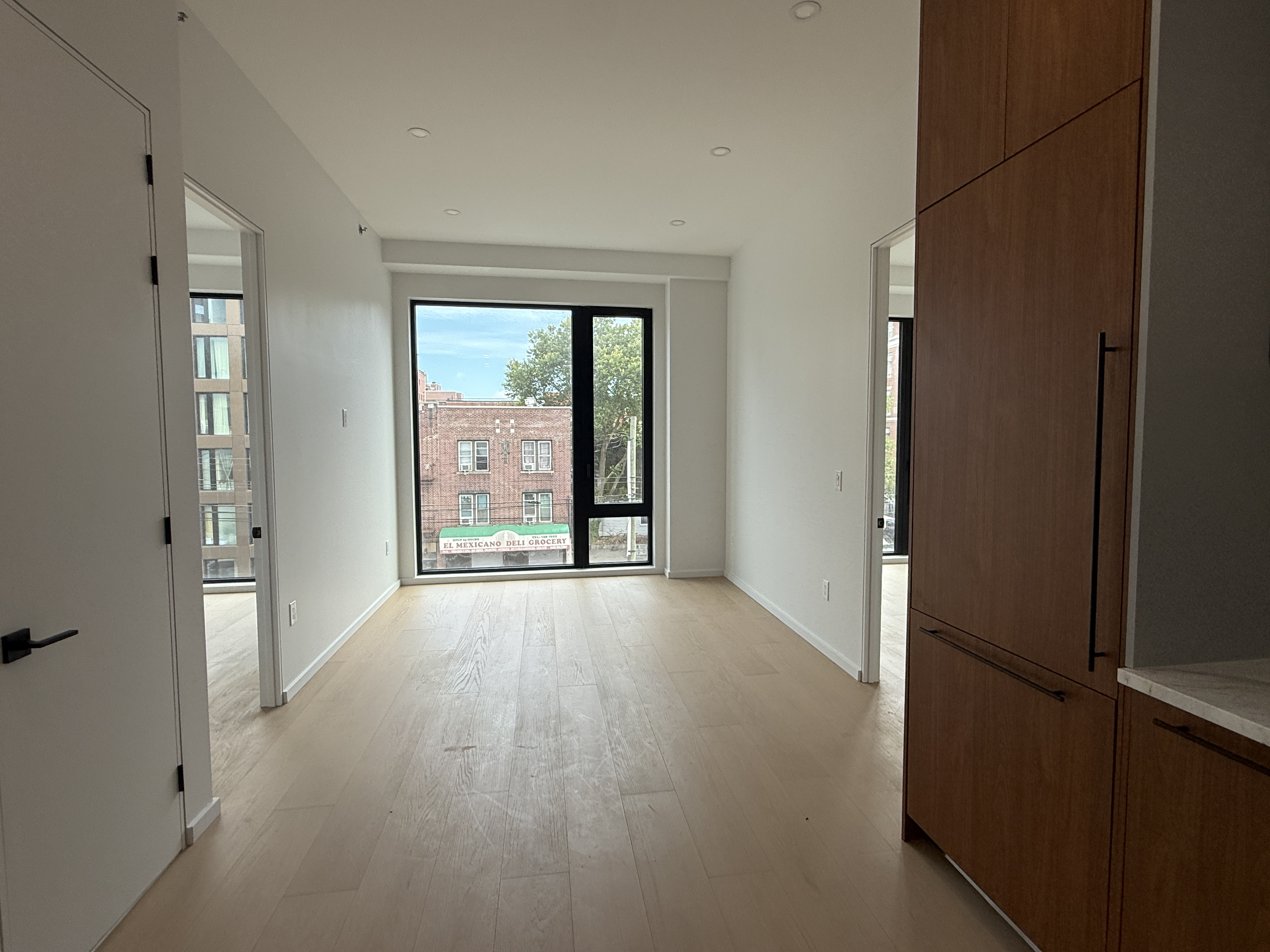 31-16 21st Street, Unit 3E Queens, NY 11106 - Photo 3 of 17 a view of an empty room with a window