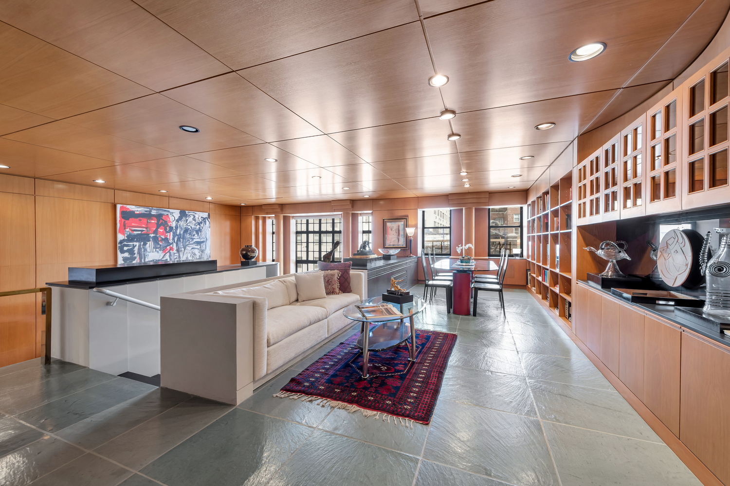 50 East 77th Street, Unit 8C Manhattan, NY 10075 - Photo 4 of 14 a living room with furniture a flat screen tv and a fireplace
