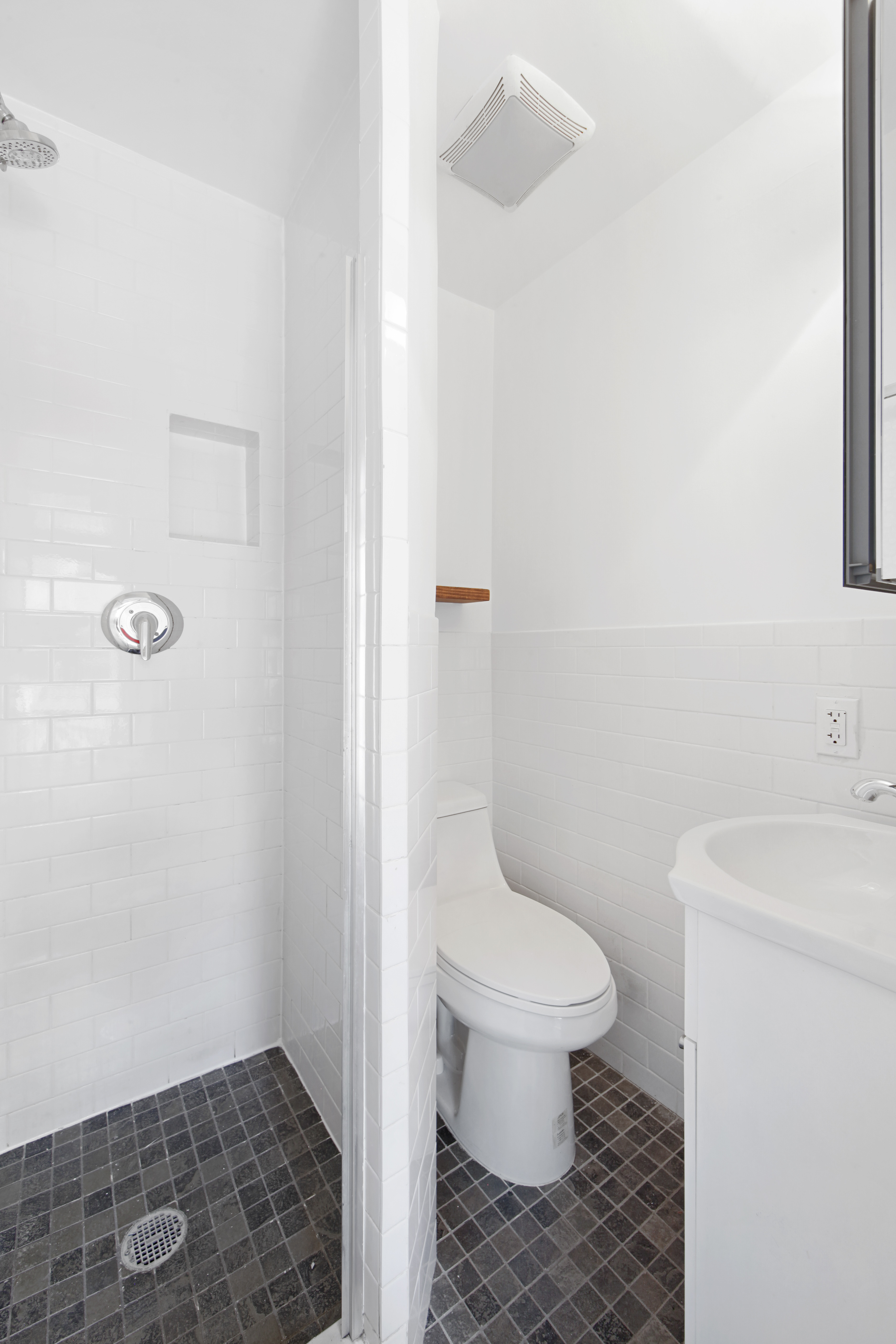 150 Sullivan Street, Unit 37 Manhattan, NY 10012 - Photo 6 of 12 a white toilet sitting next to a bathroom sink