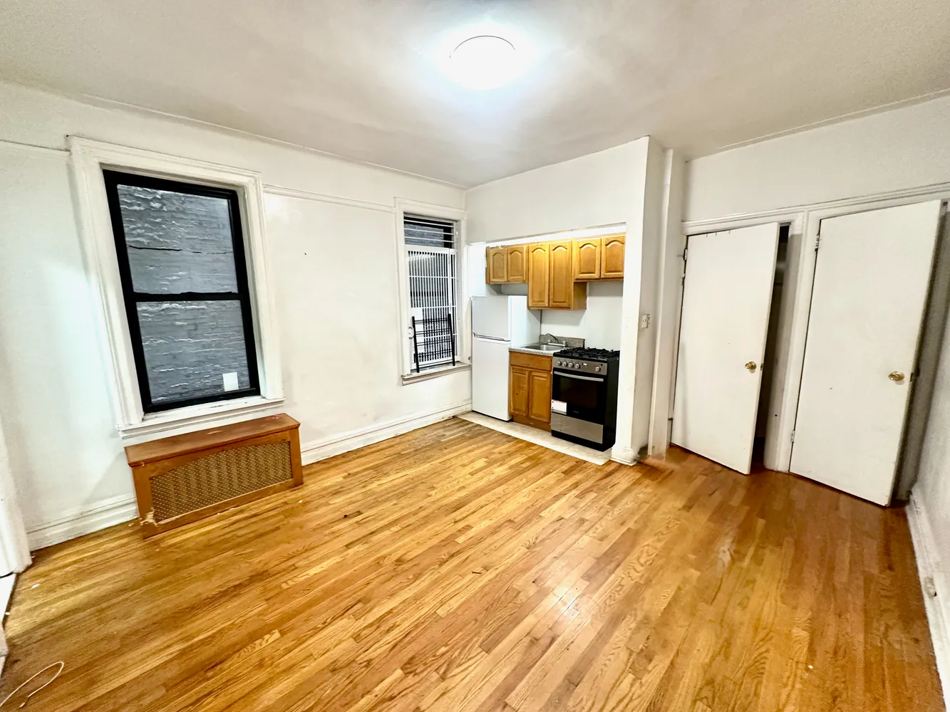 a view of a livingroom with wooden floor and a fireplace
