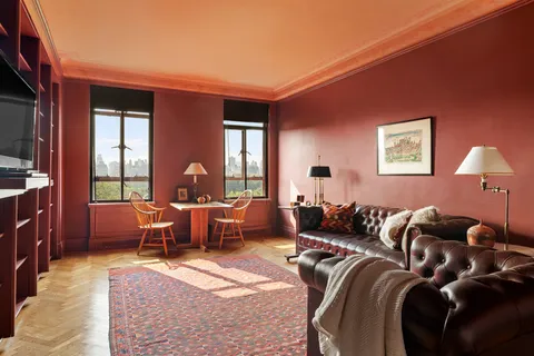 a living room with furniture a lamp and a flat screen tv