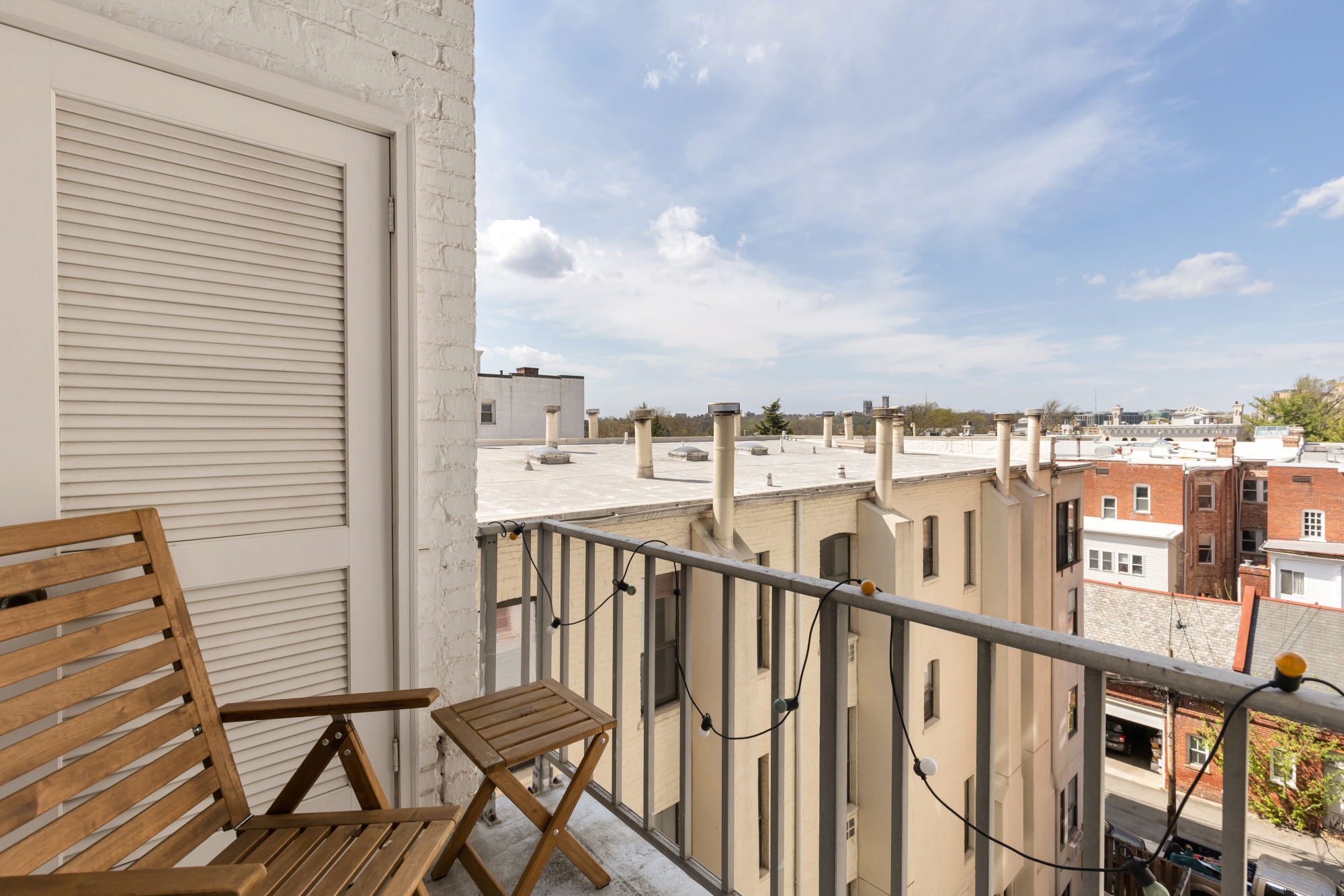 2127 California Street Northwest, Unit 505 Washington, DC 20008 - Photo 37 of 40 a view of a balcony with wooden benches