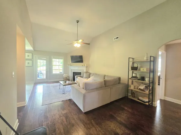a living room with furniture and a chandelier