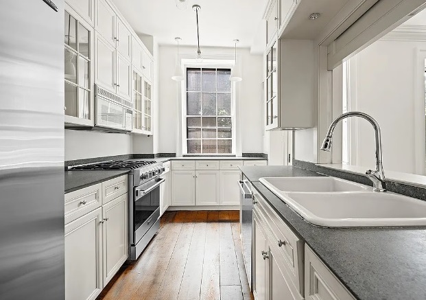138 State Street Brooklyn, NY 11201 - Photo 5 of 13 a kitchen with granite countertop a sink stainless steel appliances and window