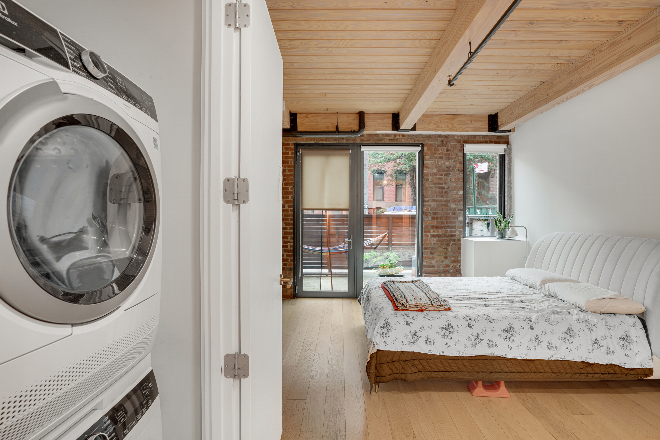 120 Java Street, Unit 1B Brooklyn, NY 11222 - Photo 6 of 12 a bedroom with a large bed and glass door