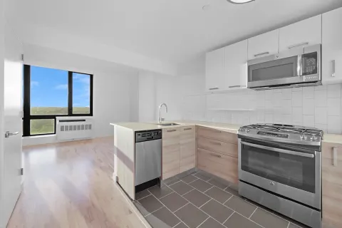 a kitchen with granite countertop cabinets stainless steel appliances and wooden floor