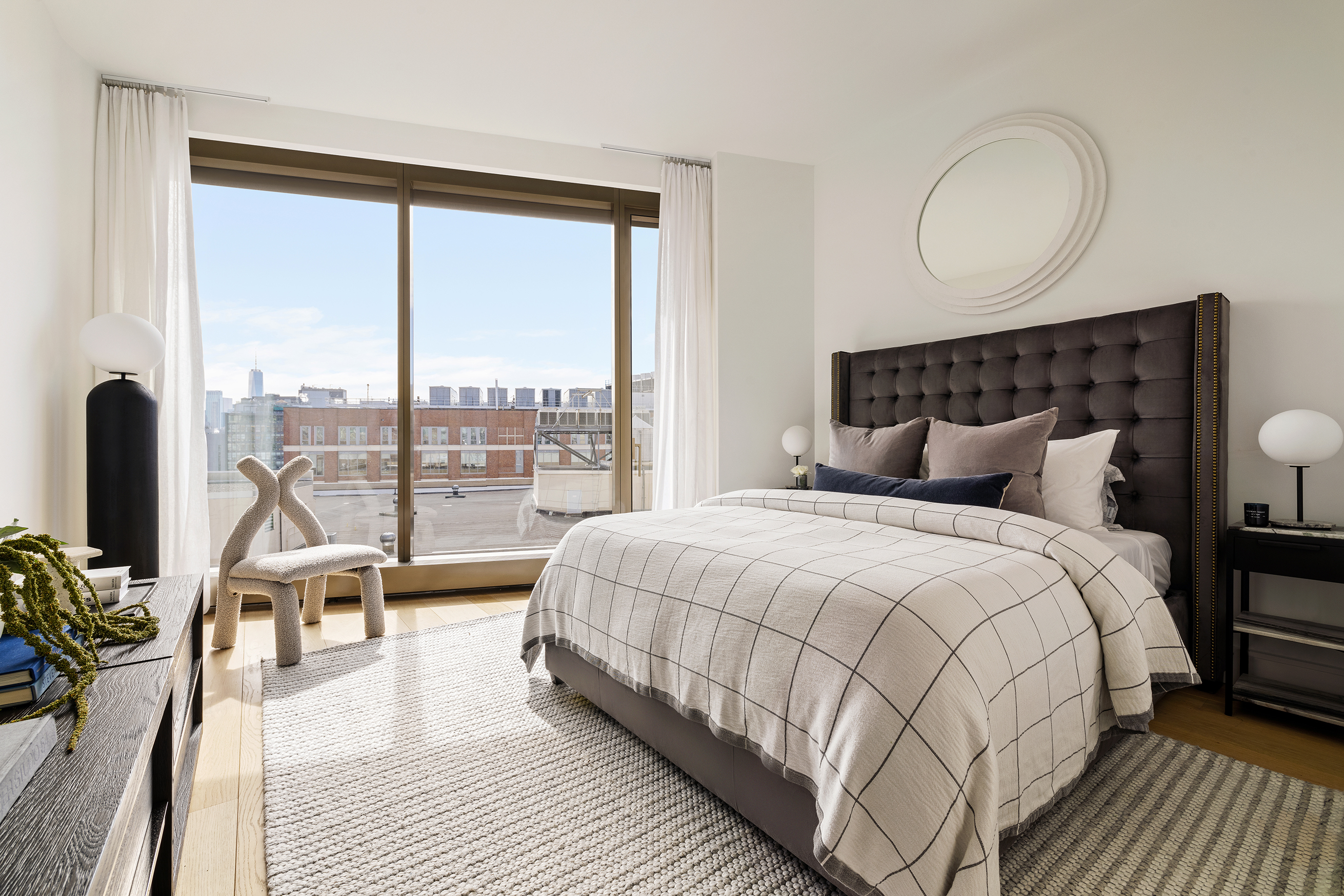 500 West 18th Street, Unit EAST 15G Manhattan, NY 10011 - Photo 10 of 26 a bedroom with a bed a lamp and a large window with balcony view