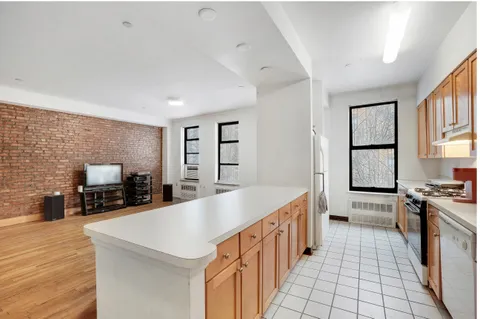 a kitchen with stainless steel appliances a stove sink microwave and cabinets
