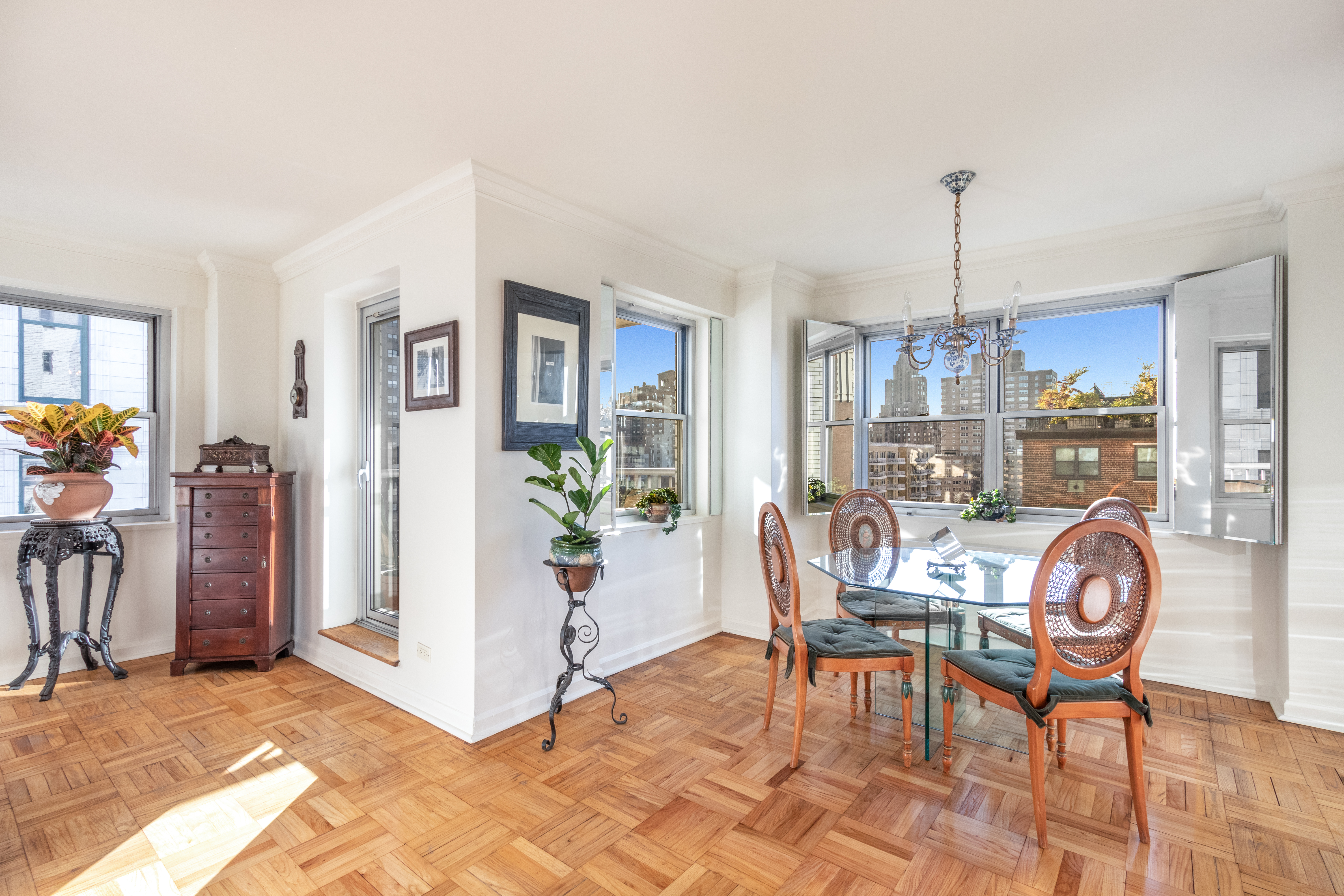 70 East 10th Street, Unit 14M Manhattan, NY 10003 - Photo 4 of 22 a view of a dining room and kitchen with furniture window and wooden floor