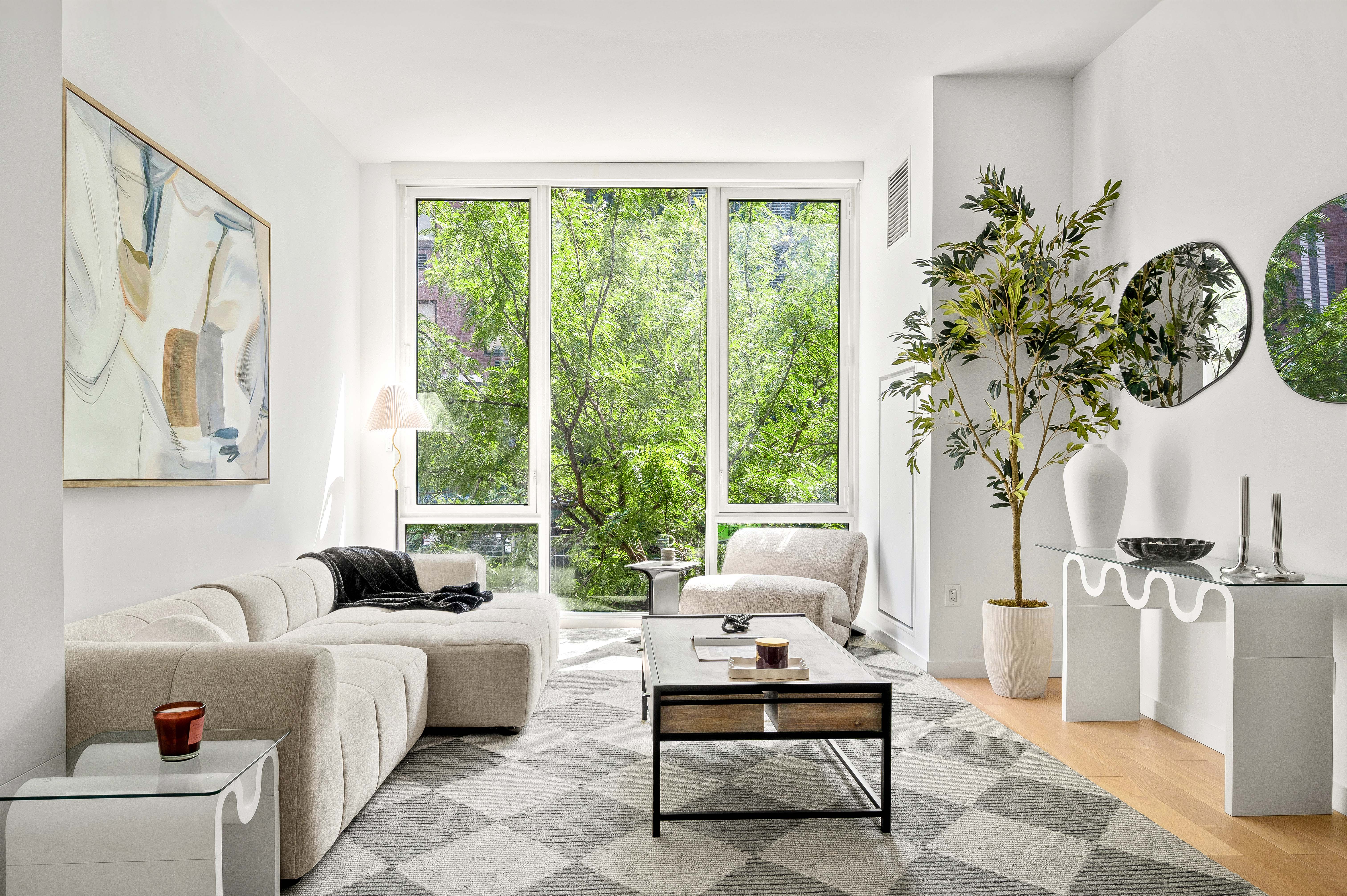 540 West 49th Street, Unit 306S Manhattan, NY 10019 - Photo 1 of 13 a living room with furniture and a large window