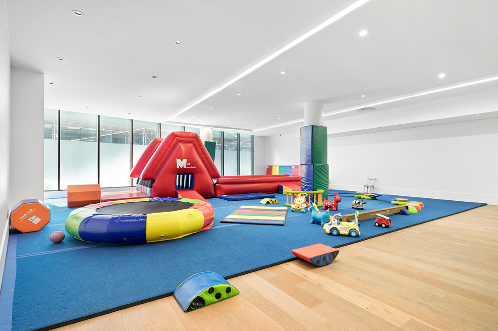 429 Kent Avenue, Unit TH8 Brooklyn, NY 11249 - Photo 17 of 24 a play room with toys and table