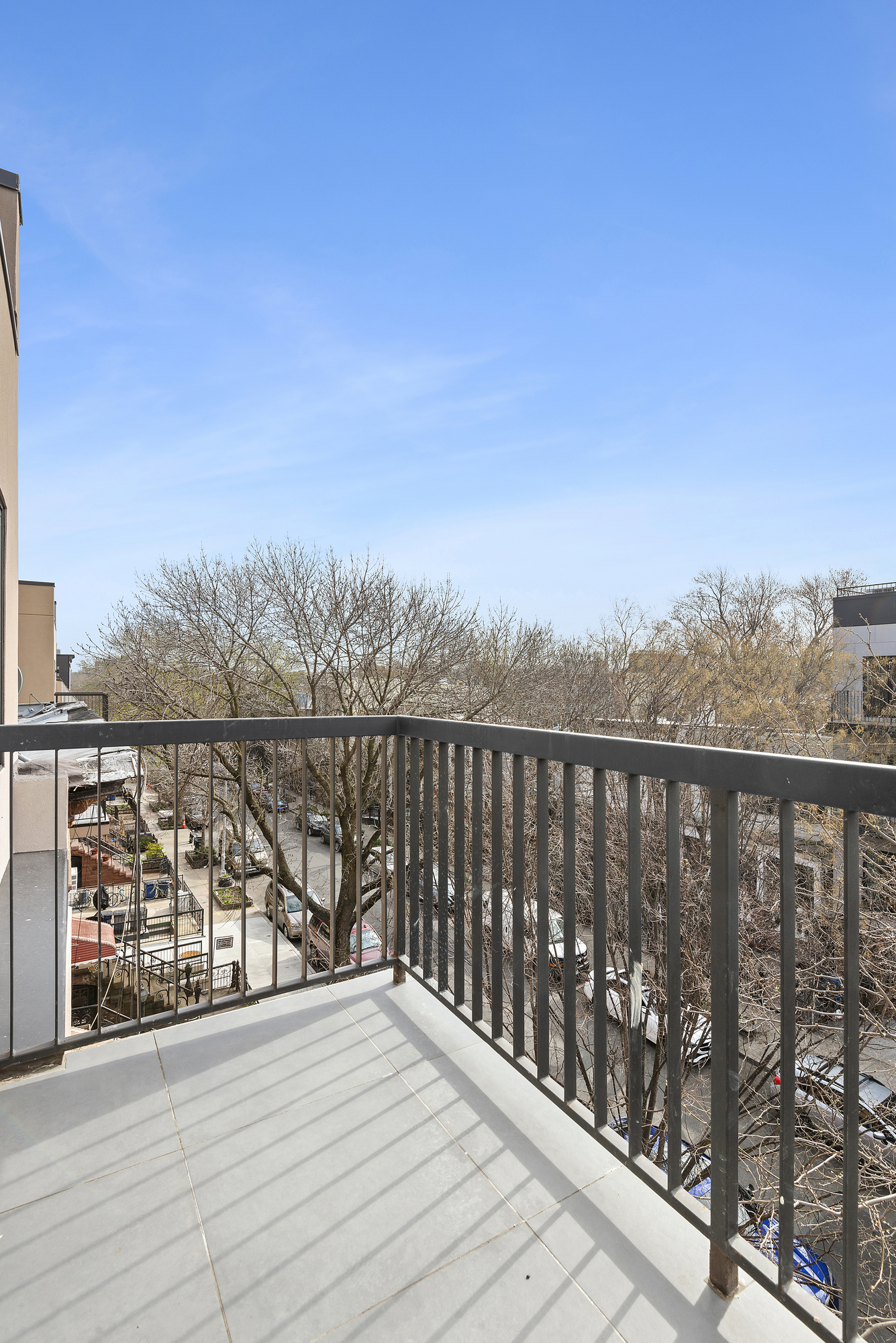 111 Woodbine Street, Unit 4 Brooklyn, NY 11221 - Photo 6 of 7 a balcony with wooden floor and city view
