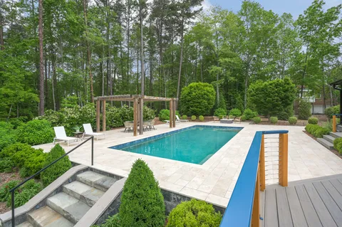 an aerial view of a house with garden space and trees