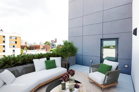 a outdoor living space with furniture and a potted plant