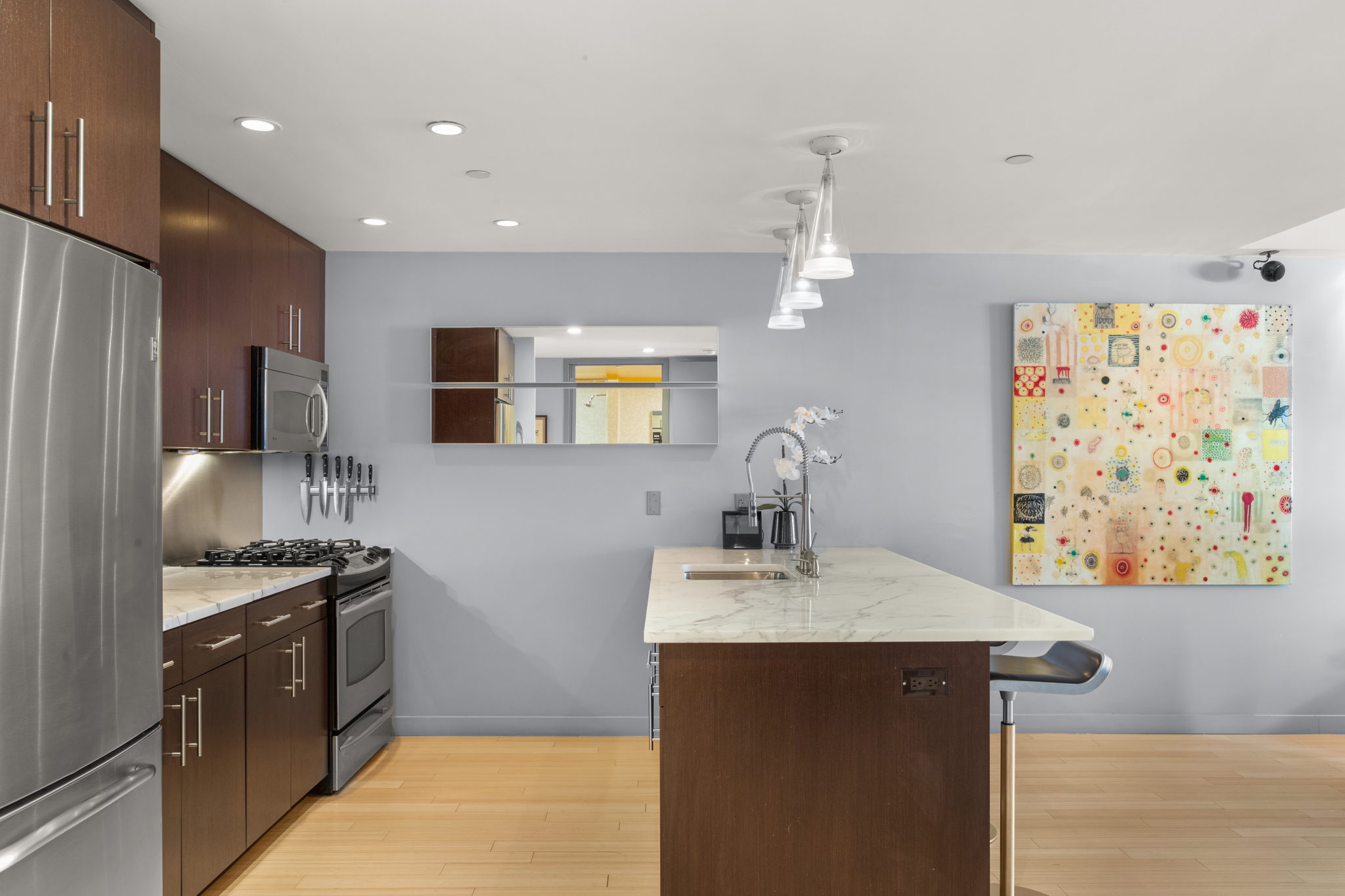 350 West 53rd Street, Unit THG Manhattan, NY 10019 - Photo 7 of 25 a kitchen with stainless steel appliances a sink stove and refrigerator
